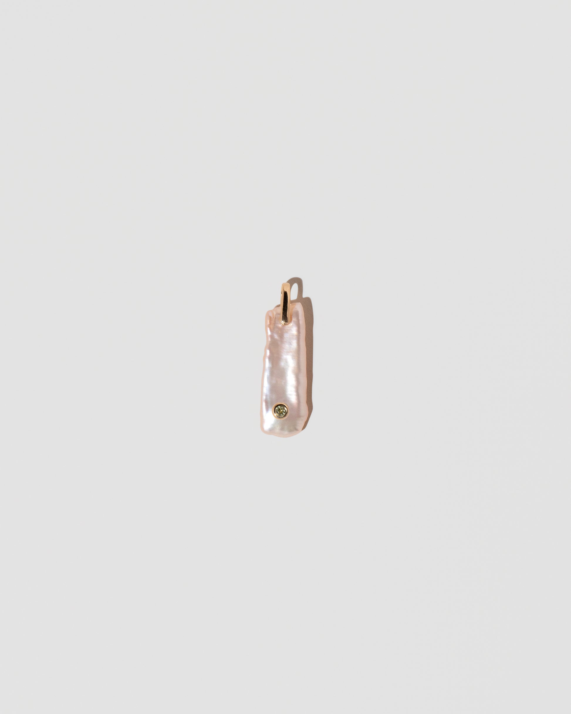 August Birthstone Pearl Pendant With Peridot on light color background.