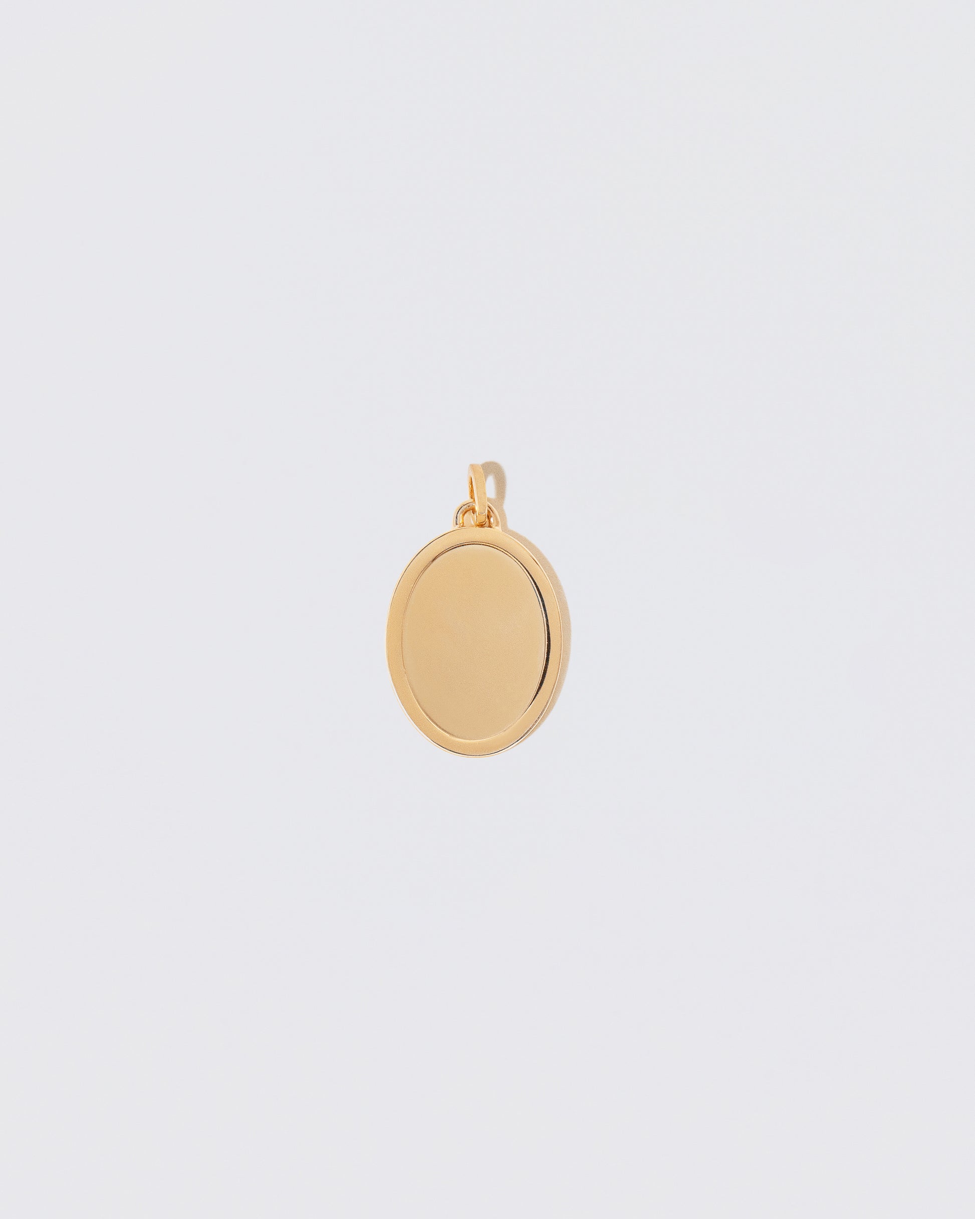 Unfinished Large Oval Pendant Memento Pendant on light color background.