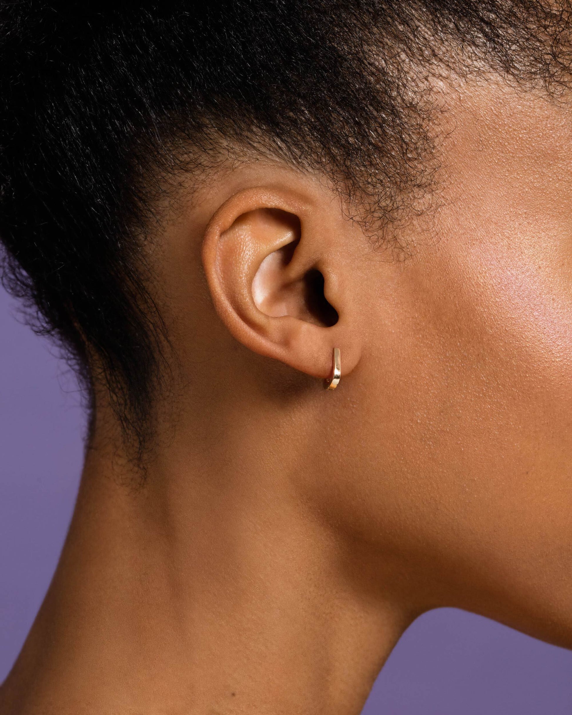 Poppy Flower Bud Huggie Hoop Earrings model.