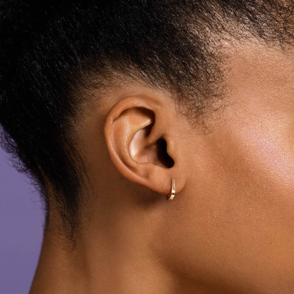 product_details::Poppy Flower Bud Huggie Hoop Earrings model.