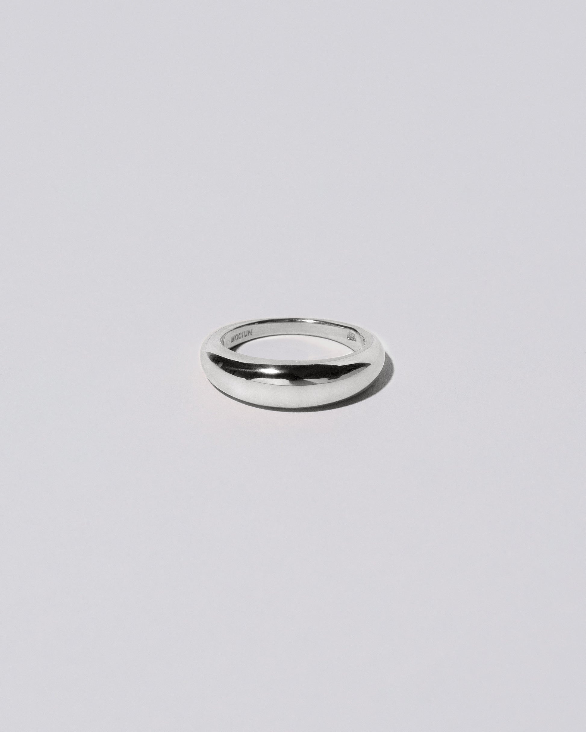 Platinum 5.5mm Venus Band on light color background.