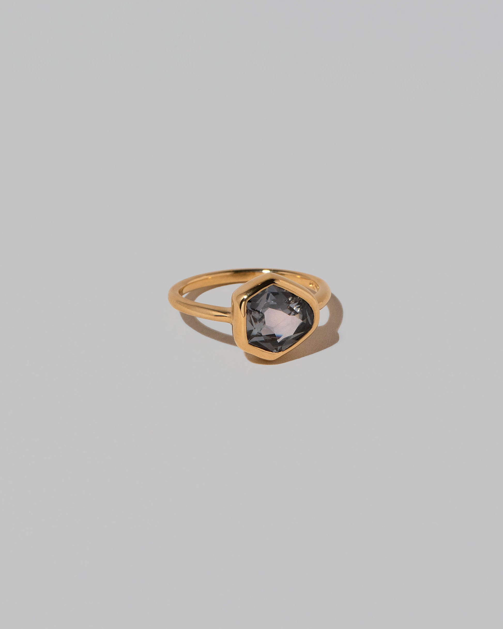 View from the side of the Geyser Purple Sapphire Ring 003 on light color background.