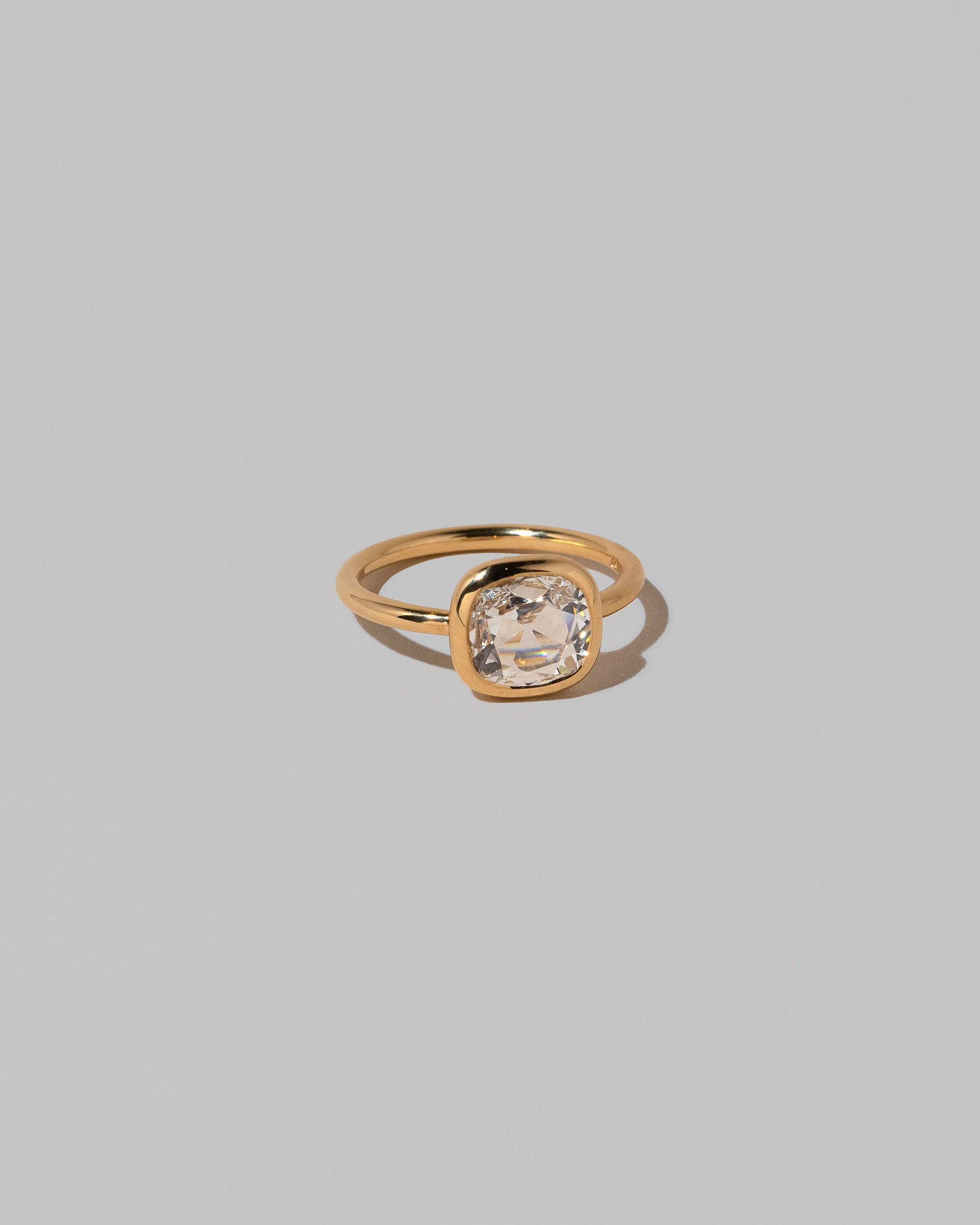 View from the side of the Gusher Diamond Ring 025 on light color background.