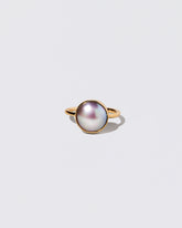 Gold Albert Ring on light color background.