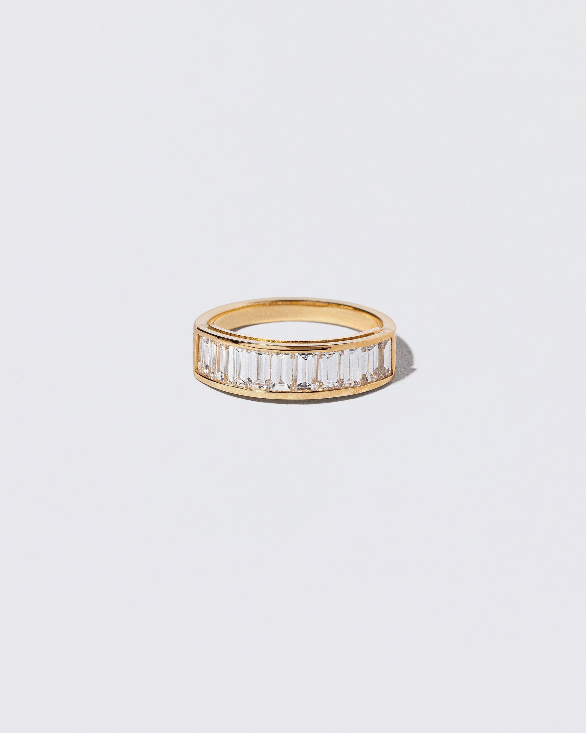 Gold Arcade Ring on light color background.