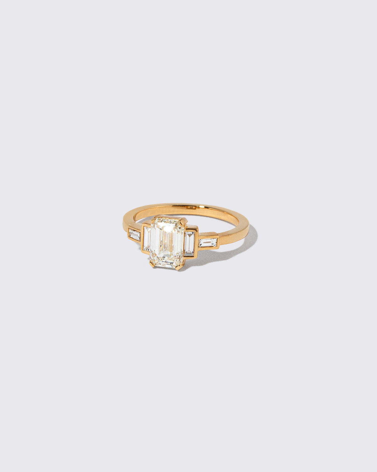 View from the side of the Diamond Assertion Ring on light color background.