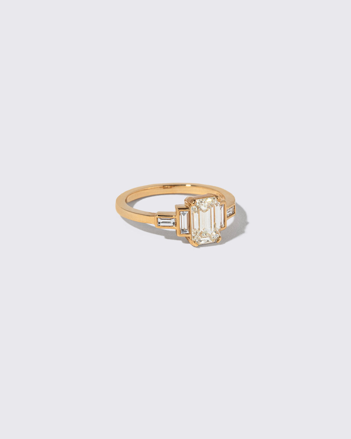 View from the side of the Diamond Assertion Ring on light color background.