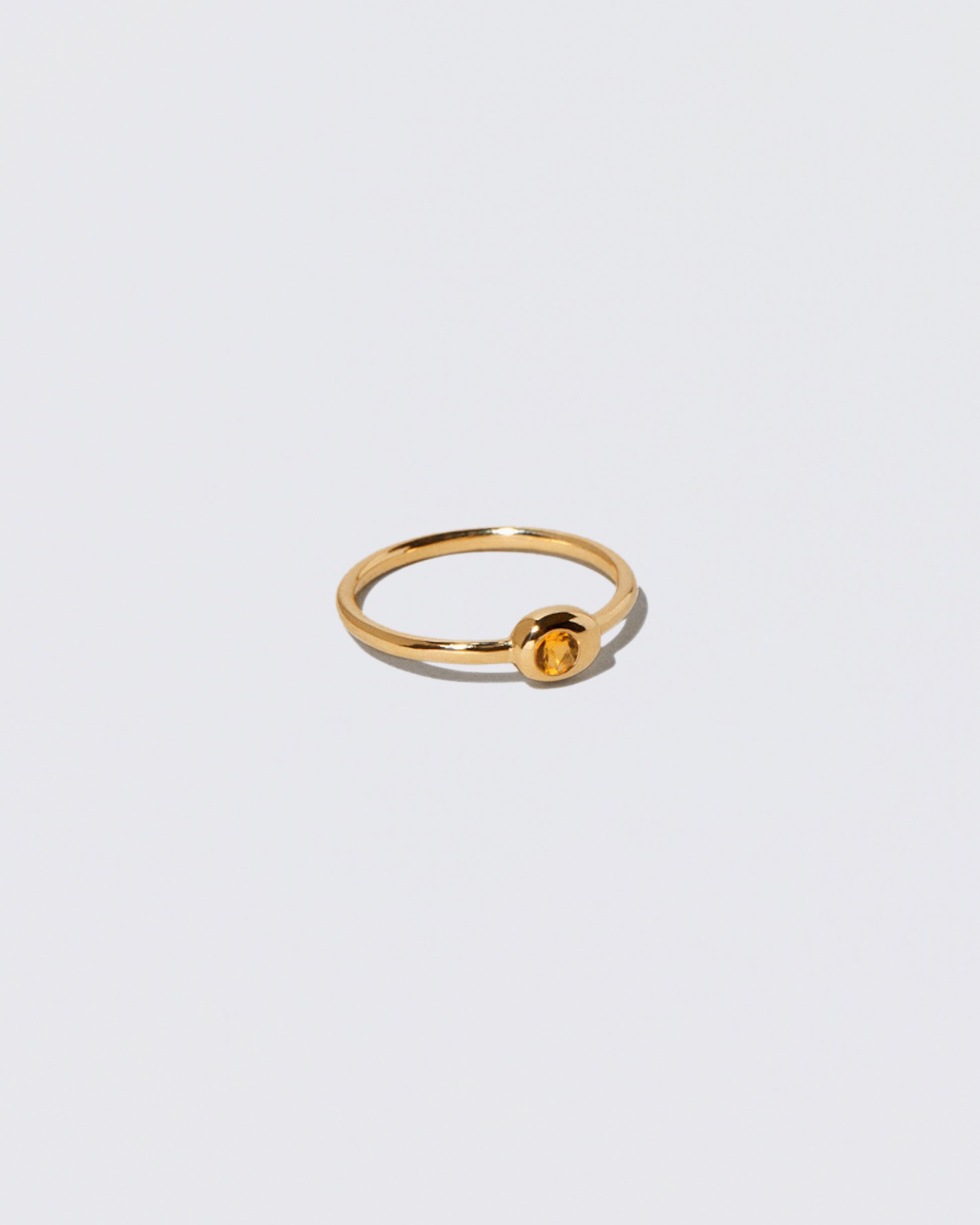 Citrine Birthstone Level Ring on light color background.
