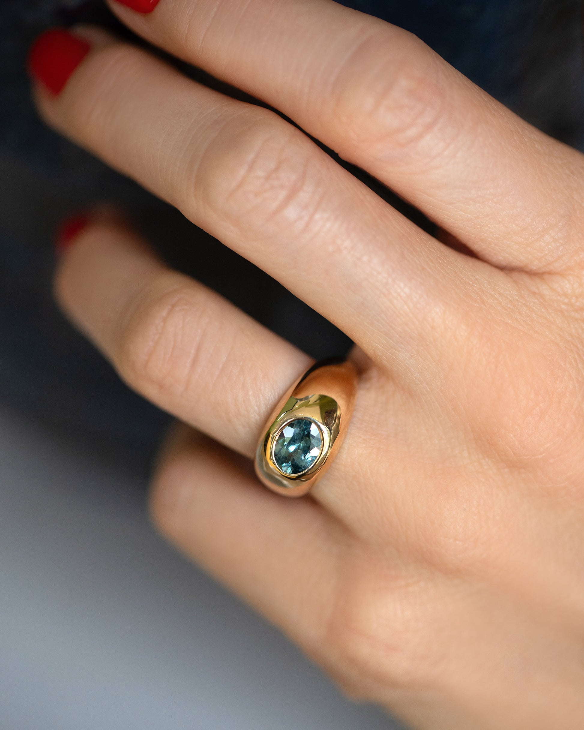 Teal Sapphire Jupiter Ring on model.