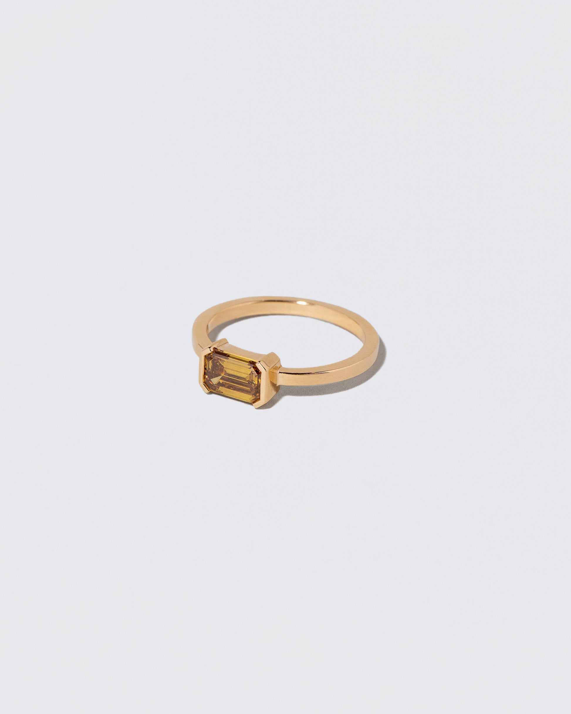 View from the side of the Brown Diamond Courtship Ring on light color background.