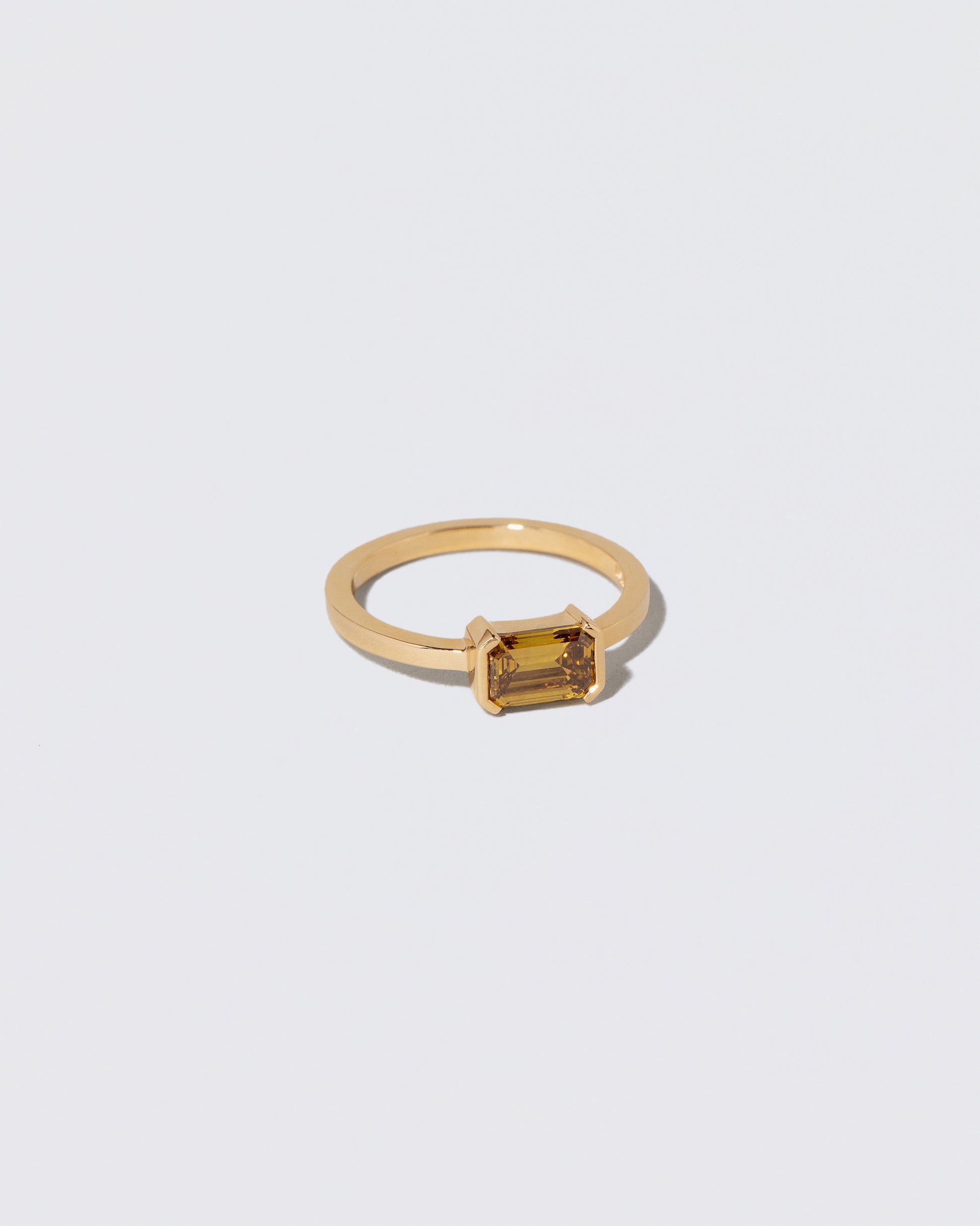 View from the side of the Brown Diamond Courtship Ring on light color background.