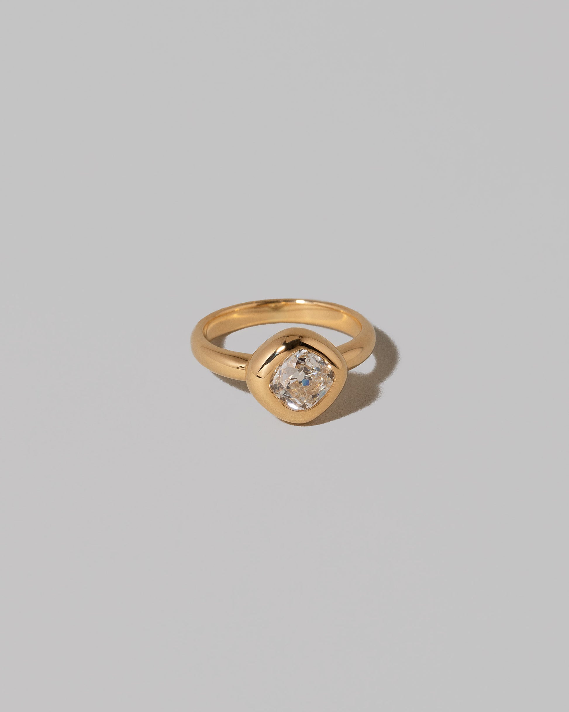 View from the side of a past edition of the  Diamond Poise Ring on light color background.