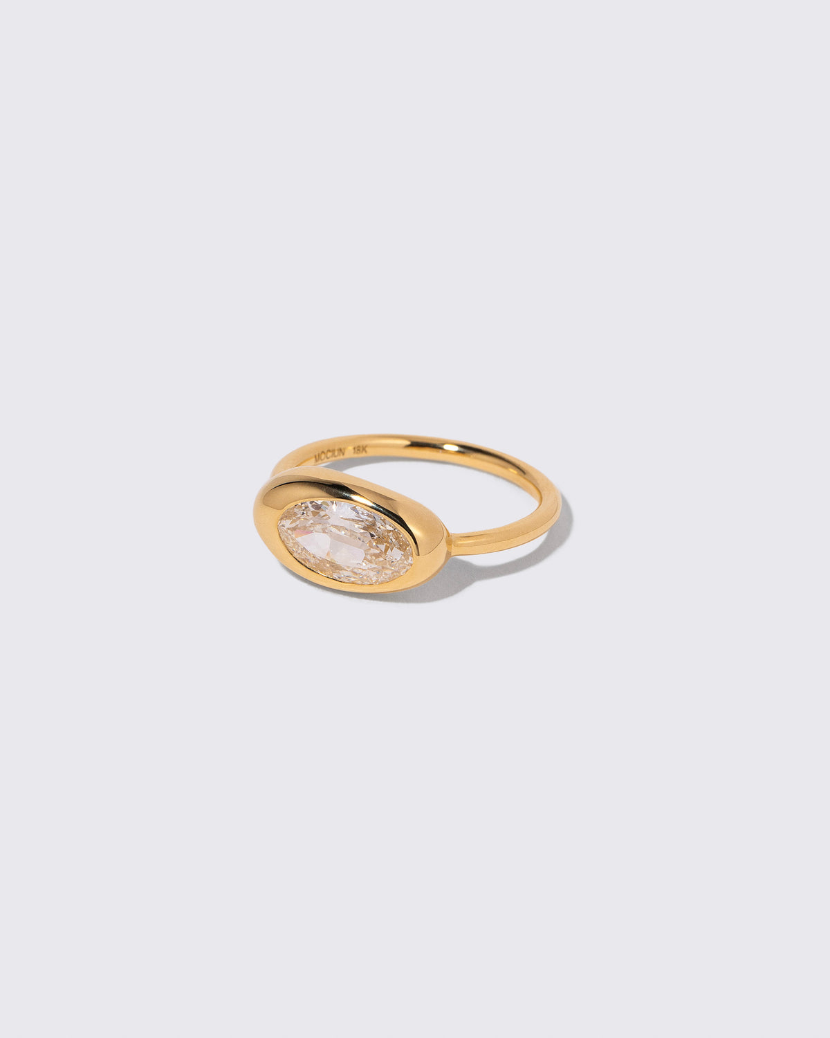View from the side of the Moval Diamond Equalize Ring on light color background.