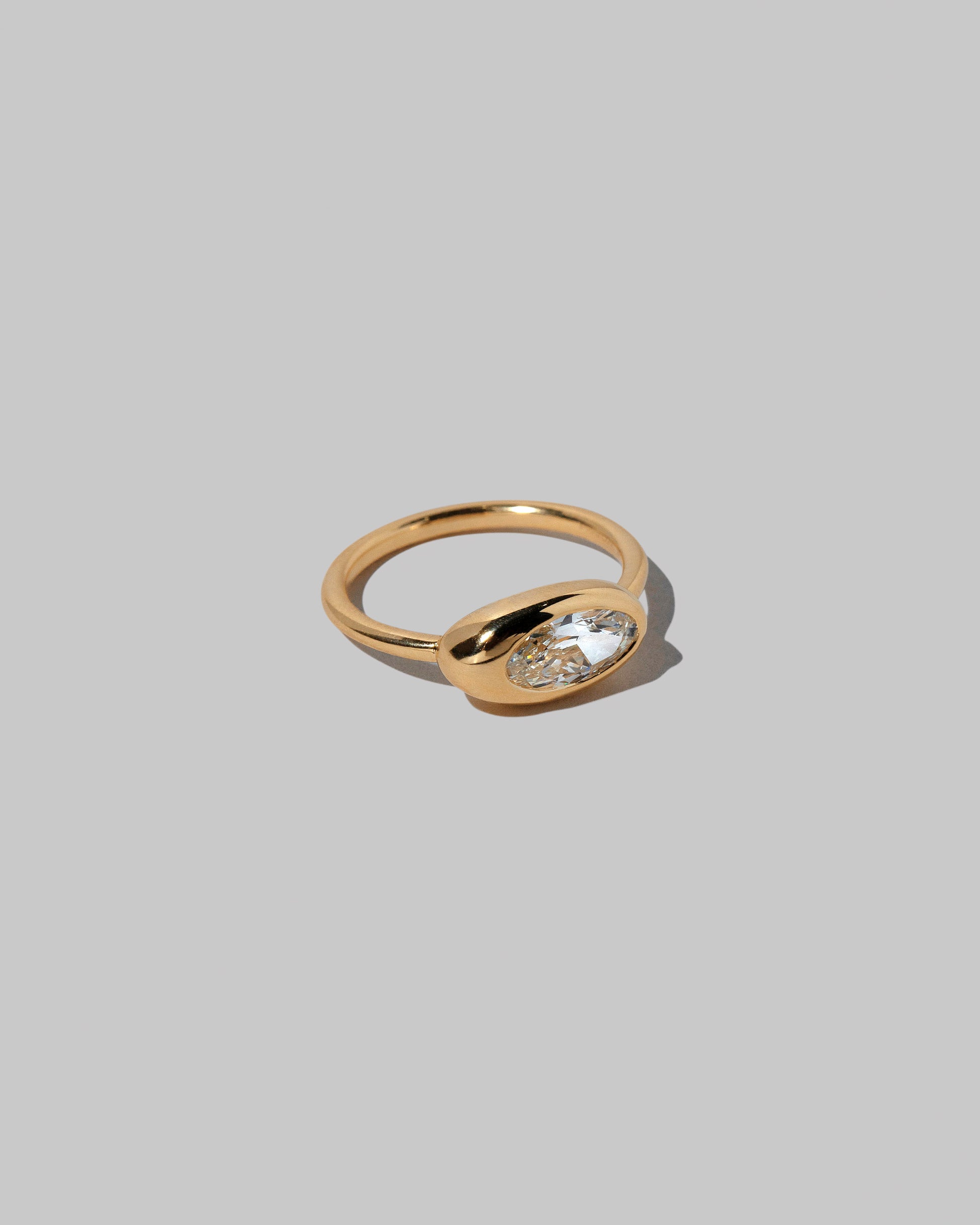 View from the side of the Moval White Diamond Equalize Ring on light color background.