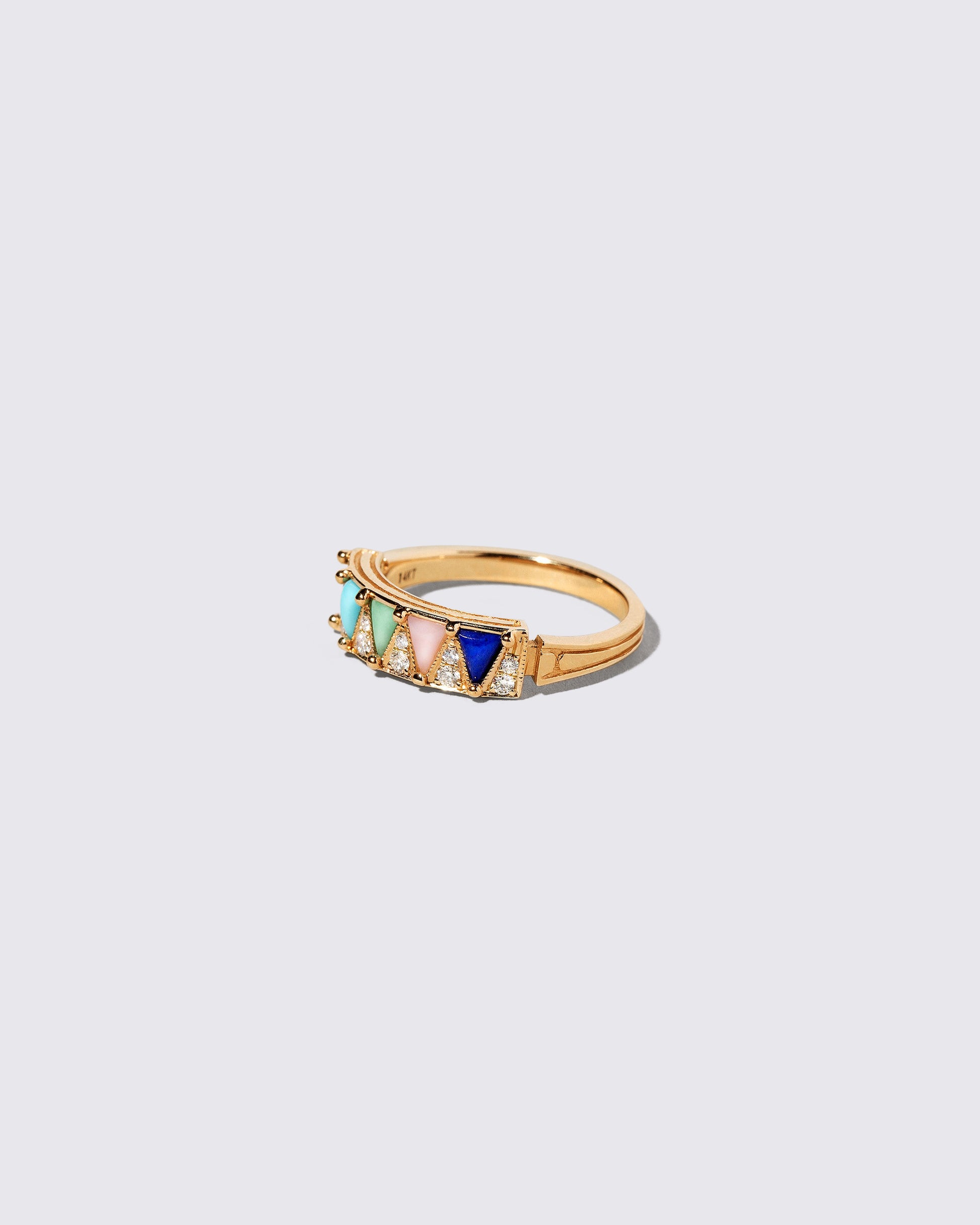 View from the side of the Gold Mega Five Triangle Ring on light color background.