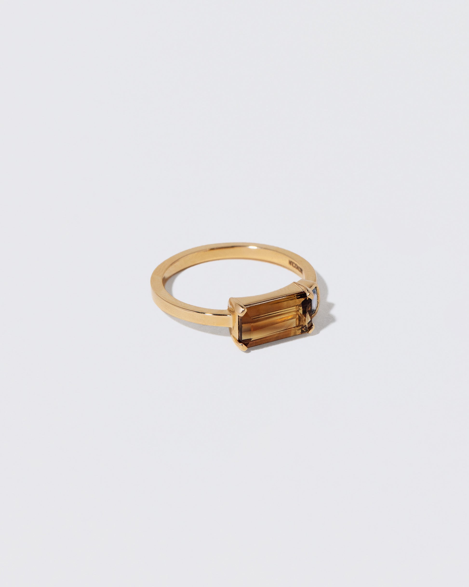 View from the side of the Golden Aura Ring on light color background.