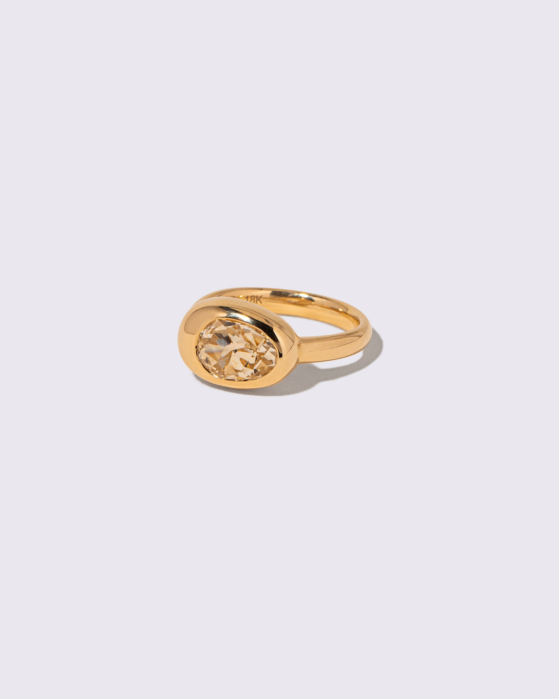 View from the side of the Sapphire Grand Align Ring on light color background.