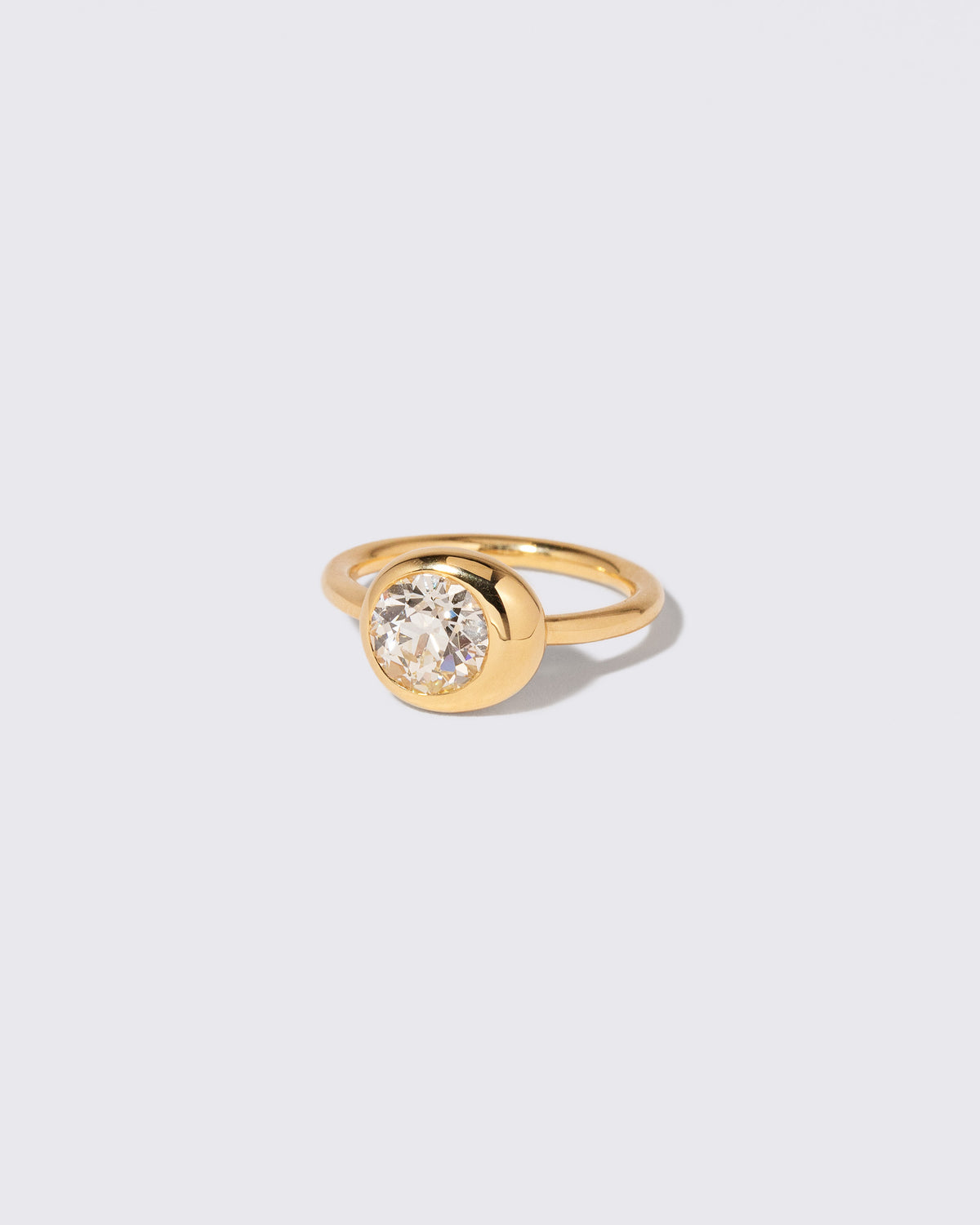 View from the side of the Diamond Grand Level Ring on light color background.