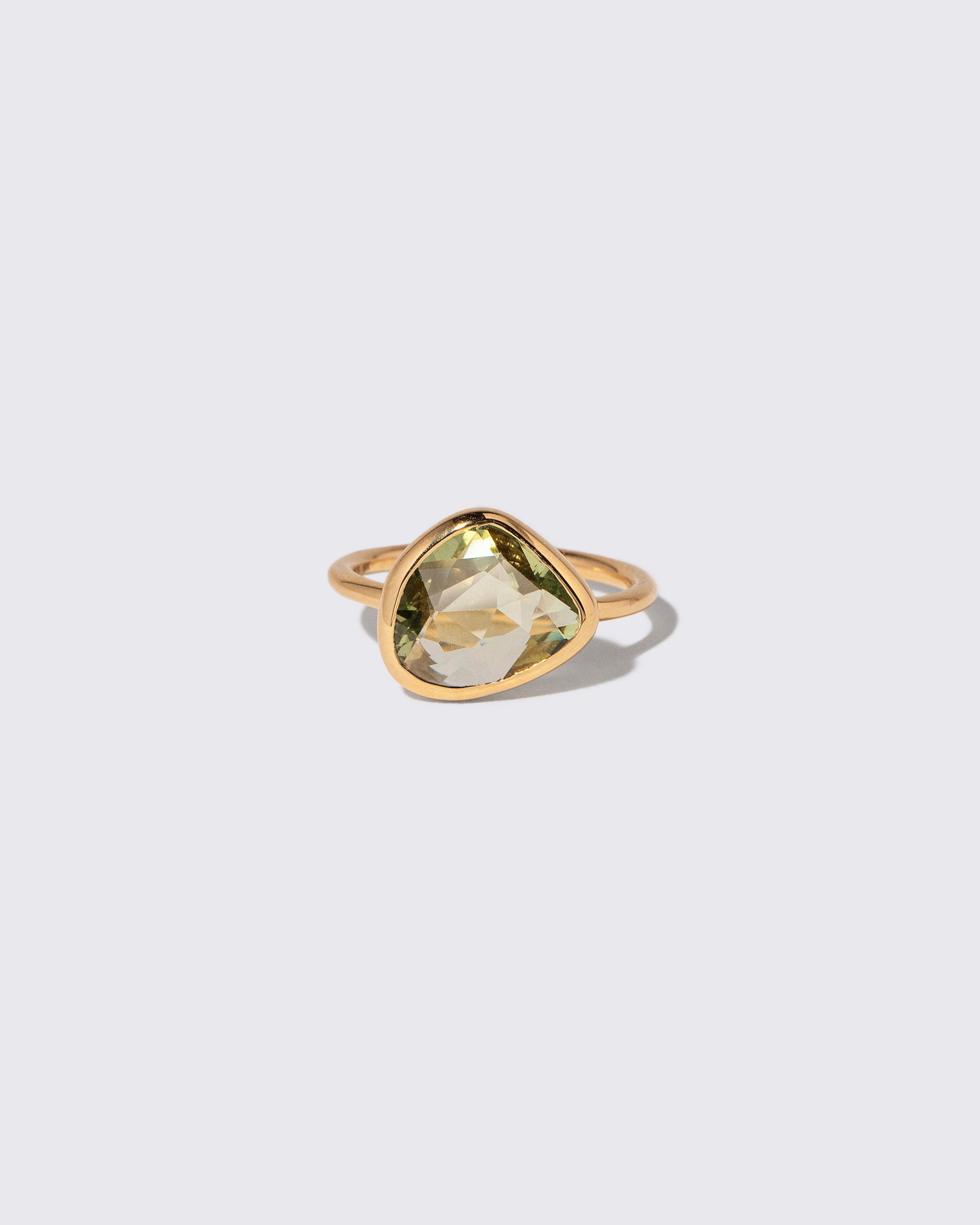 Green Sapphire Gusher Ring on light color background.