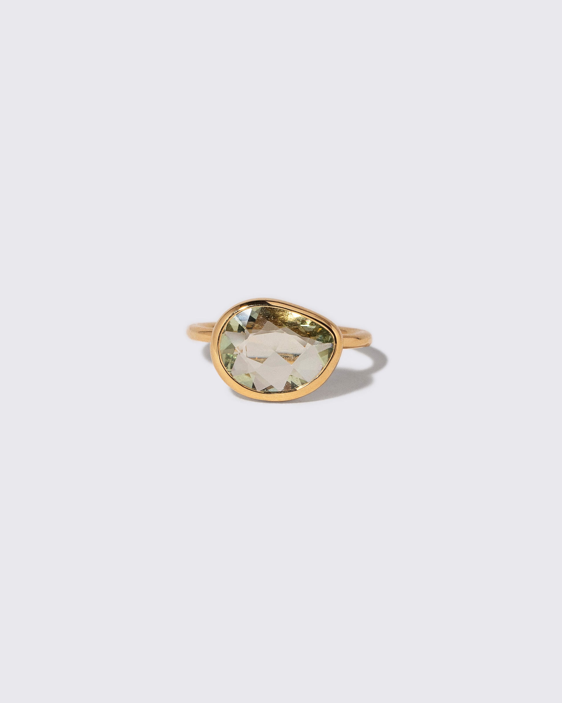 Green Sapphire Gusher Ring on light color background.