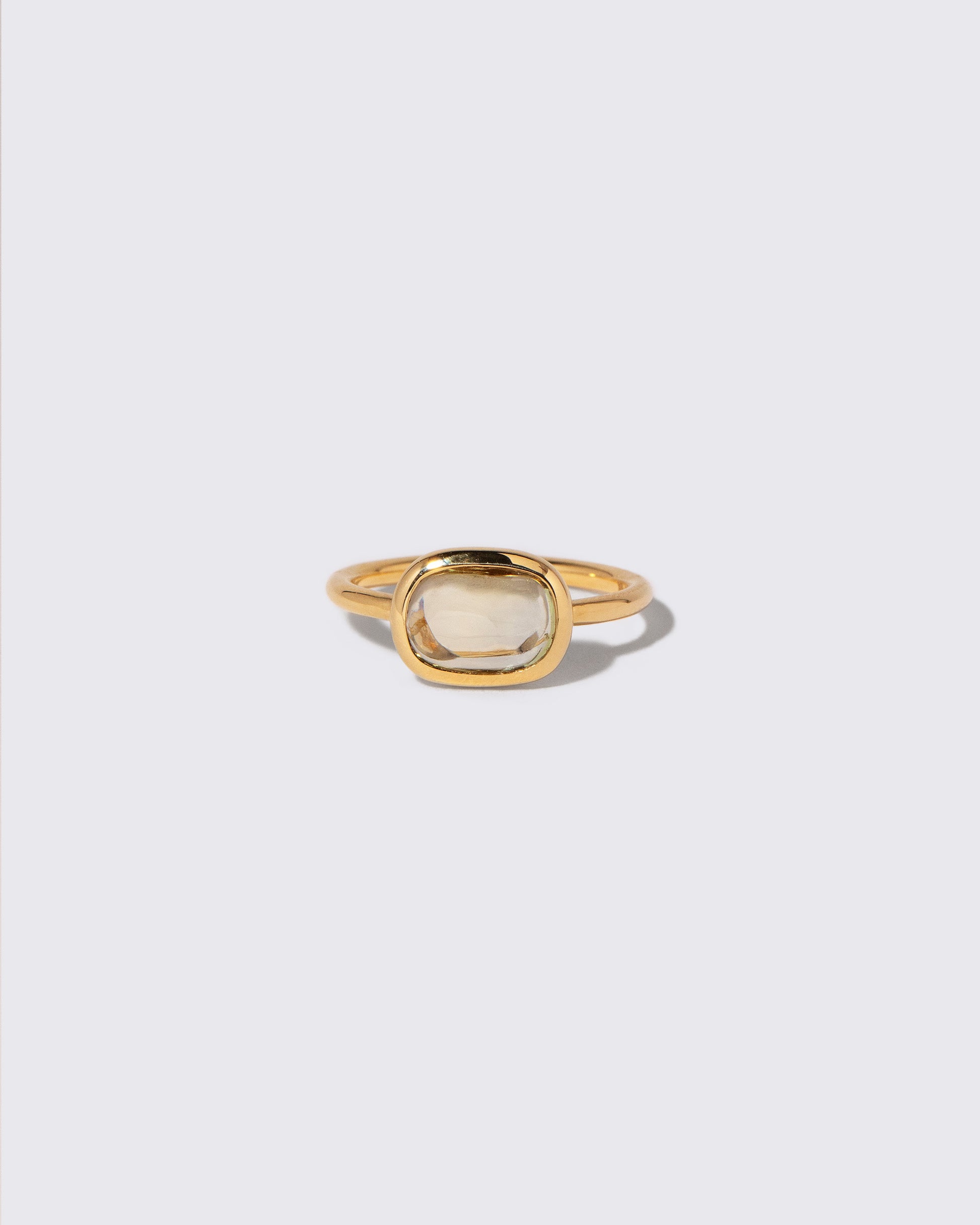 Green Sapphire Gusher Ring on light color background.