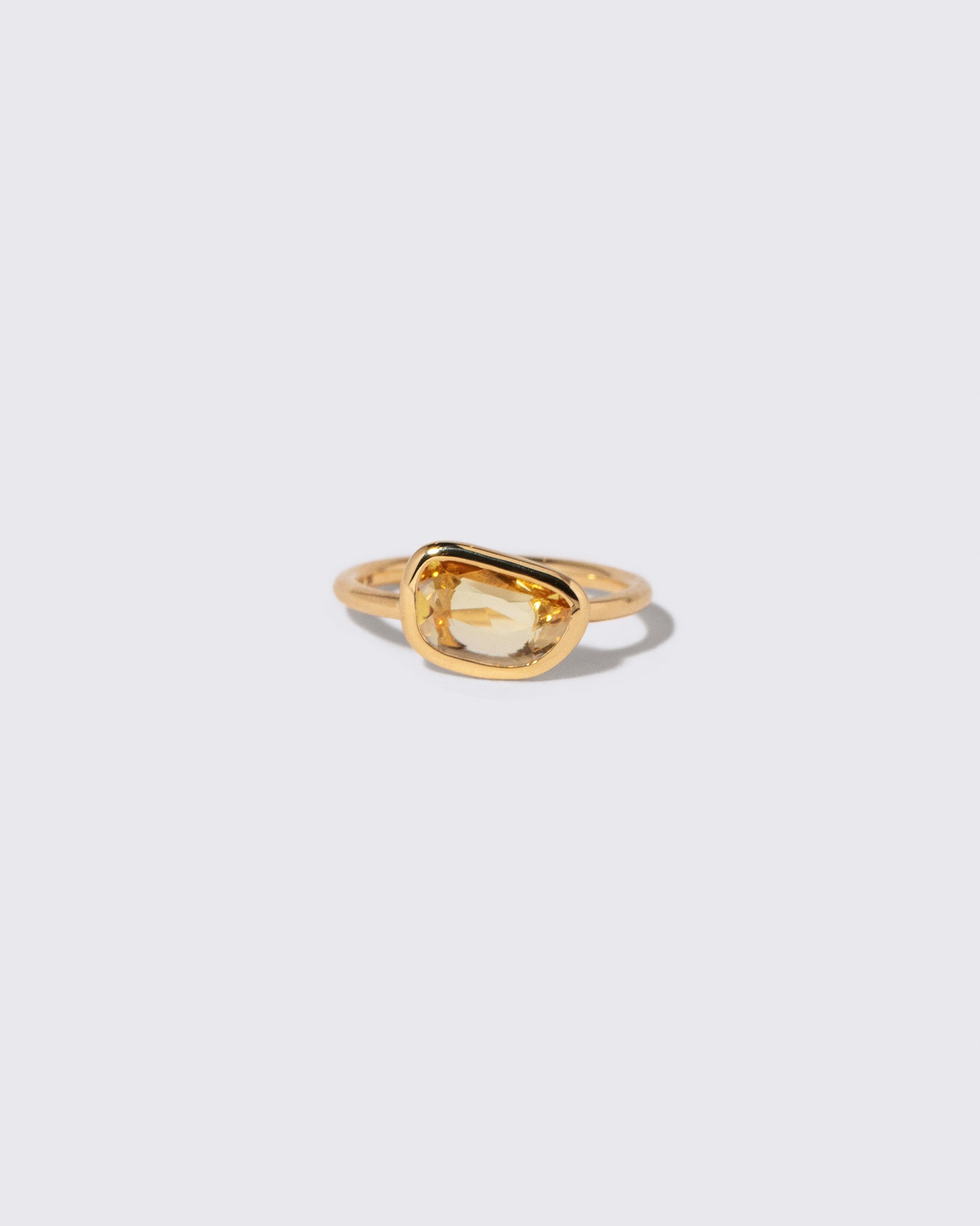 Yellow Sapphire Gusher Ring on light color background.