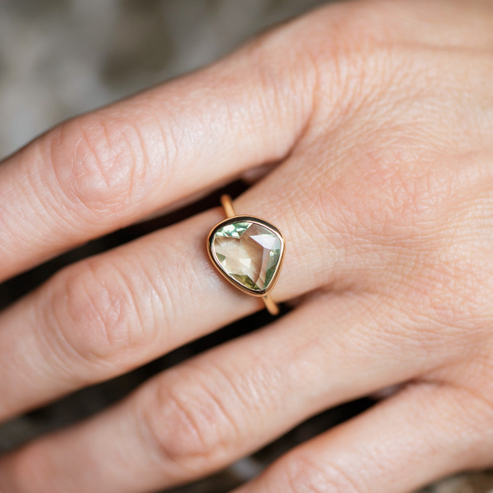 product_details::Green Sapphire Gusher Ring on model.
