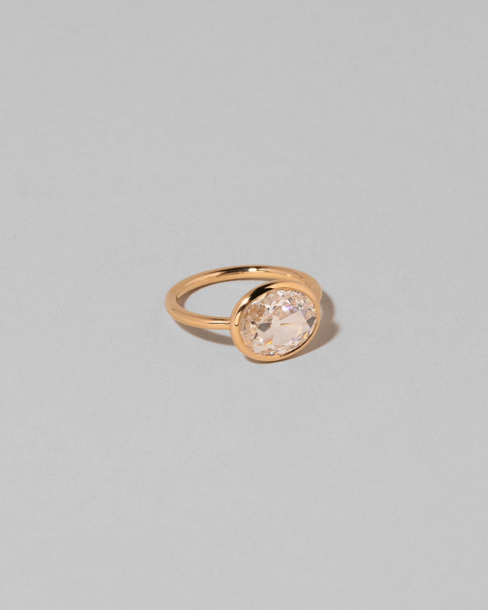View from the side of the Gusher Diamond Ring 001 on light color background.