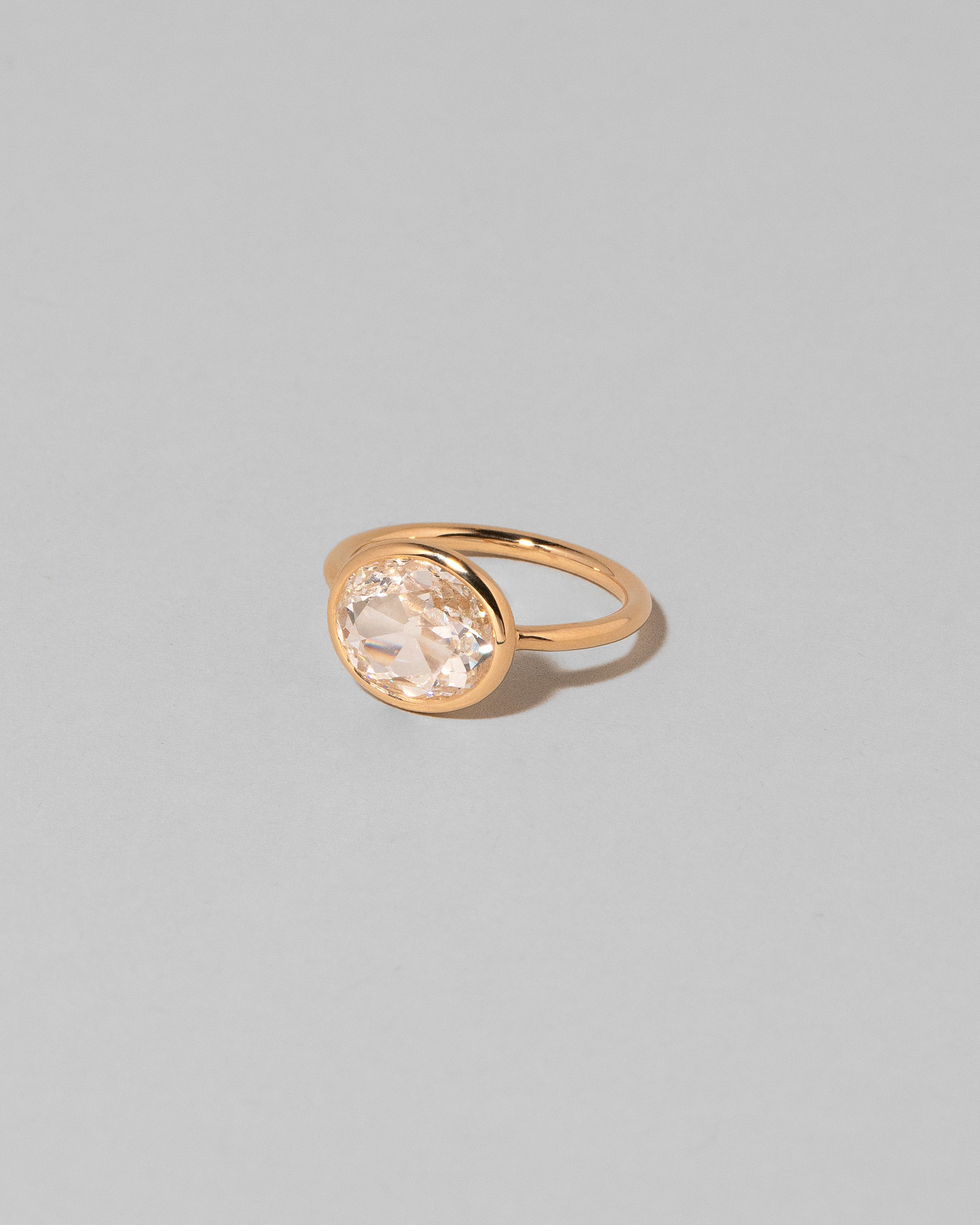 View from the side of the Gusher Diamond Ring 001 on light color background.