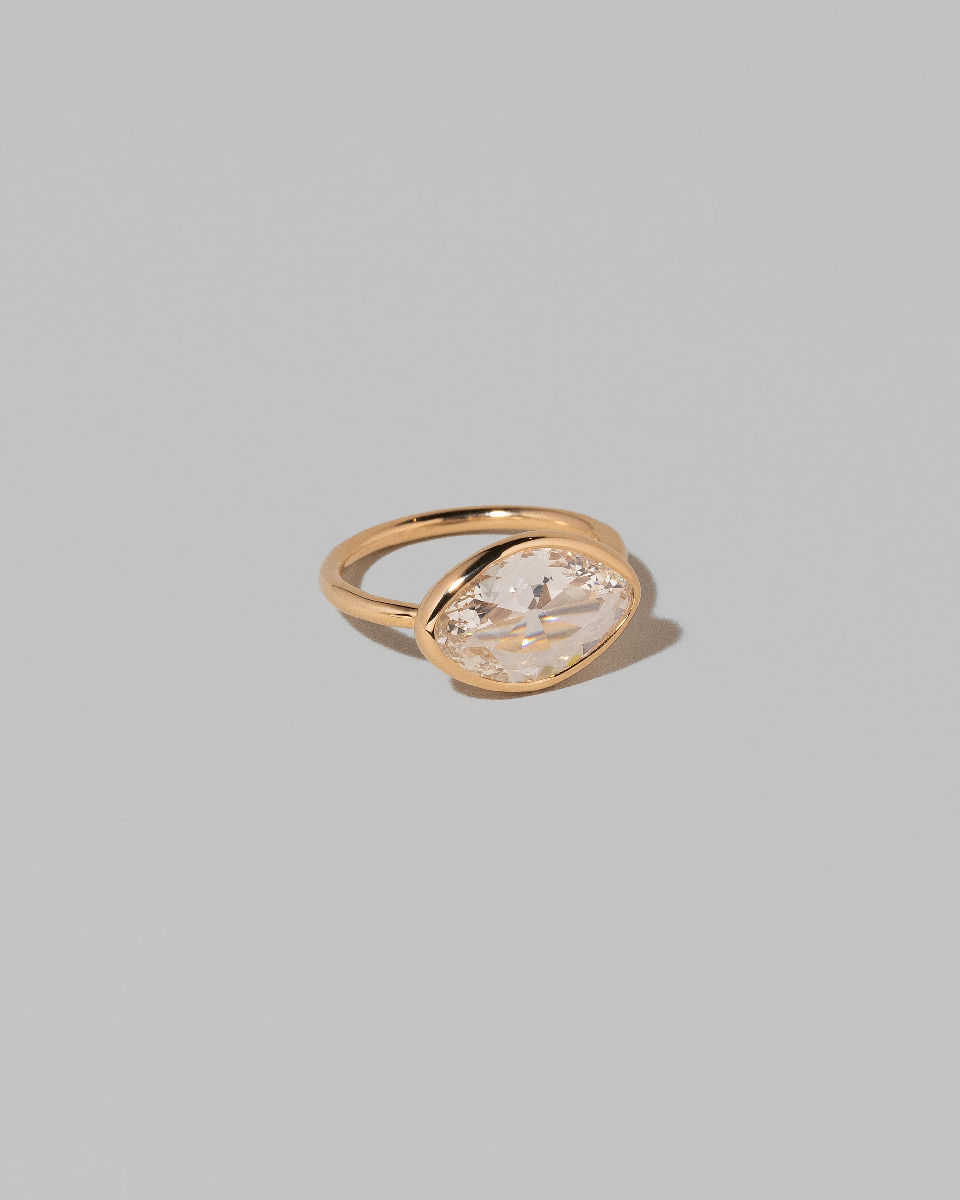 View from the side of the Gusher Diamond Ring 007 on light color background.