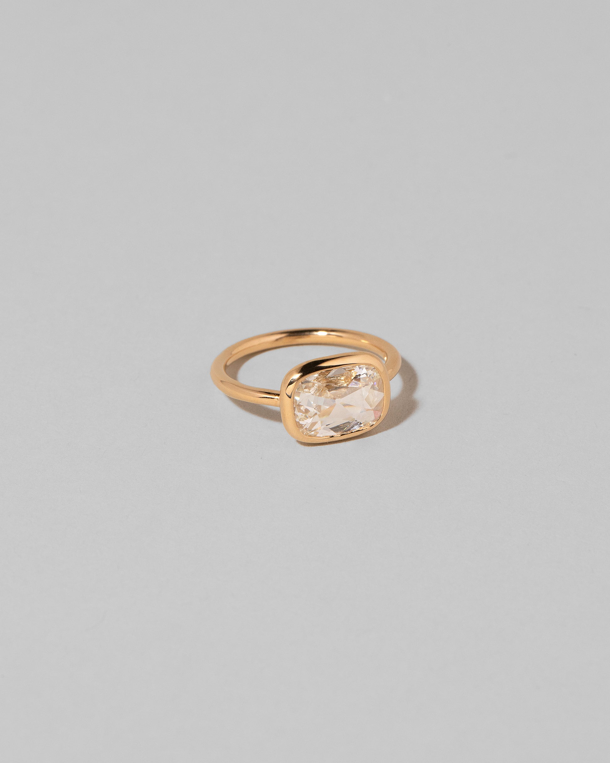 View from the side of the Gusher Diamond Ring 010 on light color background.