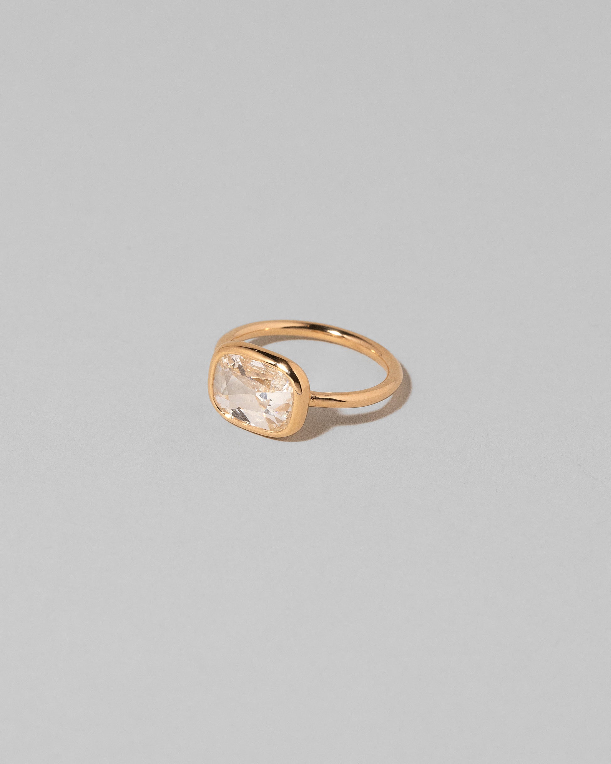 View from the side of the Gusher Diamond Ring 010 on light color background.