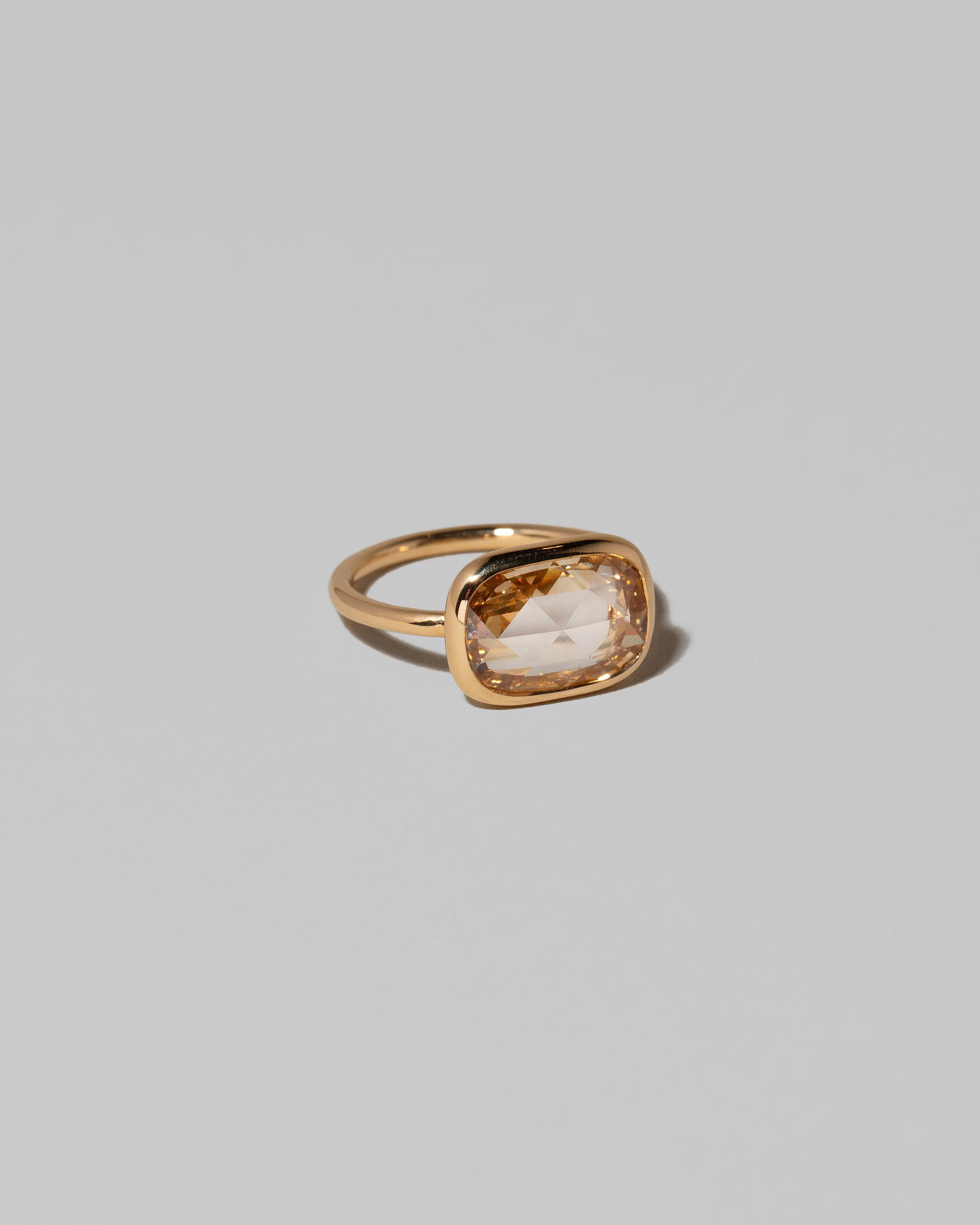 View from the side of the Gusher Diamond Ring 013 on light color background.