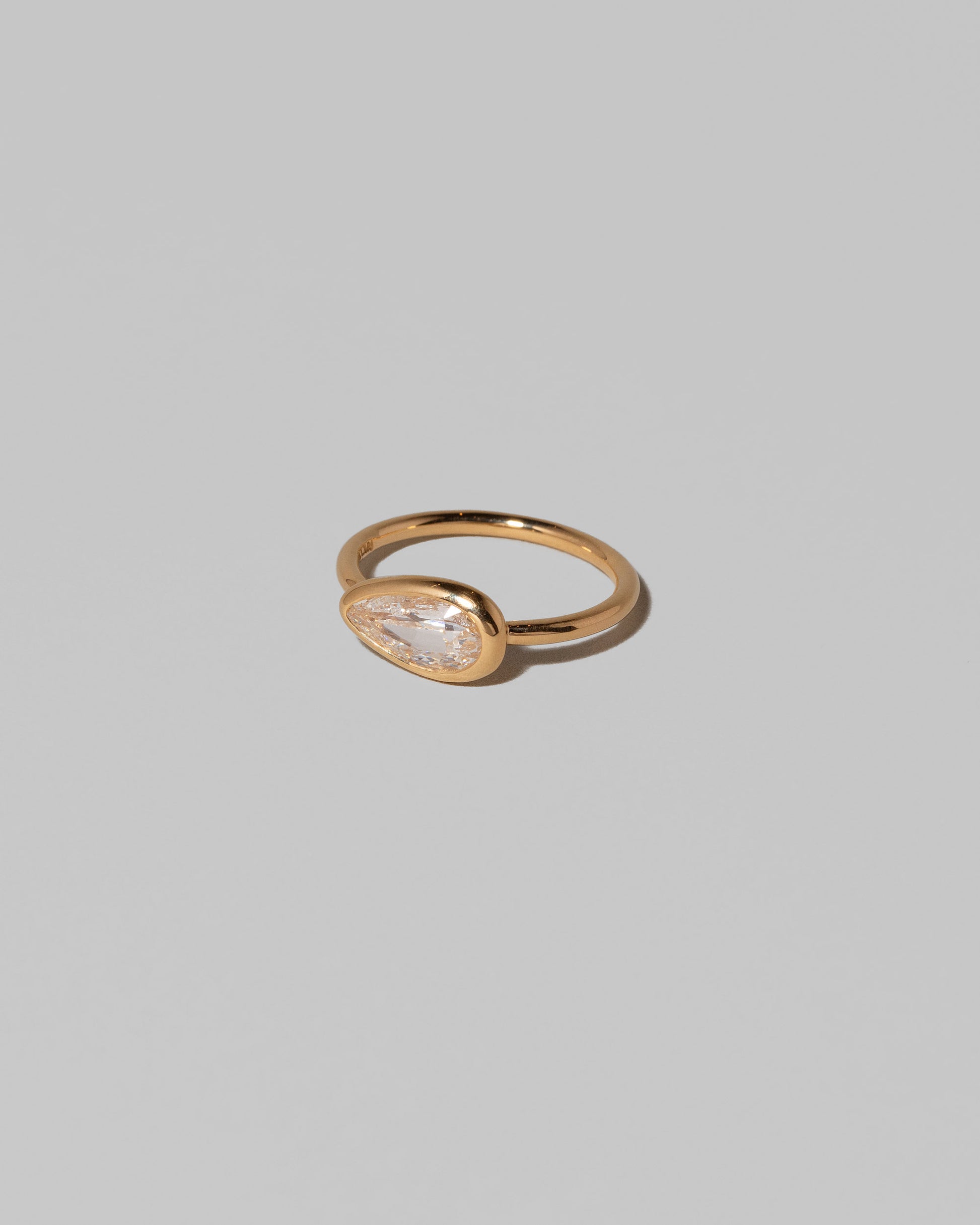 View from the side of the Gusher Diamond Ring 014 on light color background.