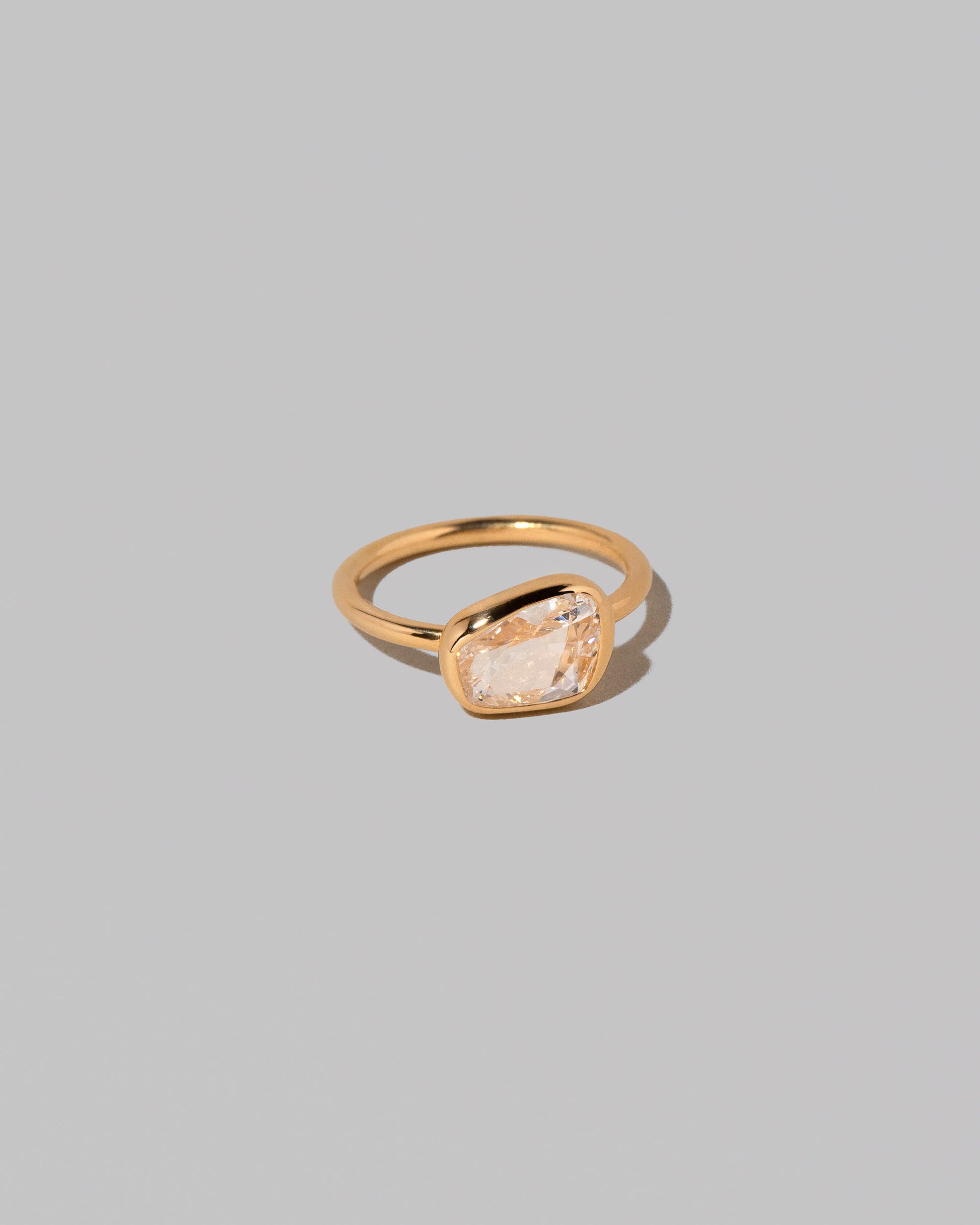 View from the side of the Gusher Diamond Ring 016 on light color background.