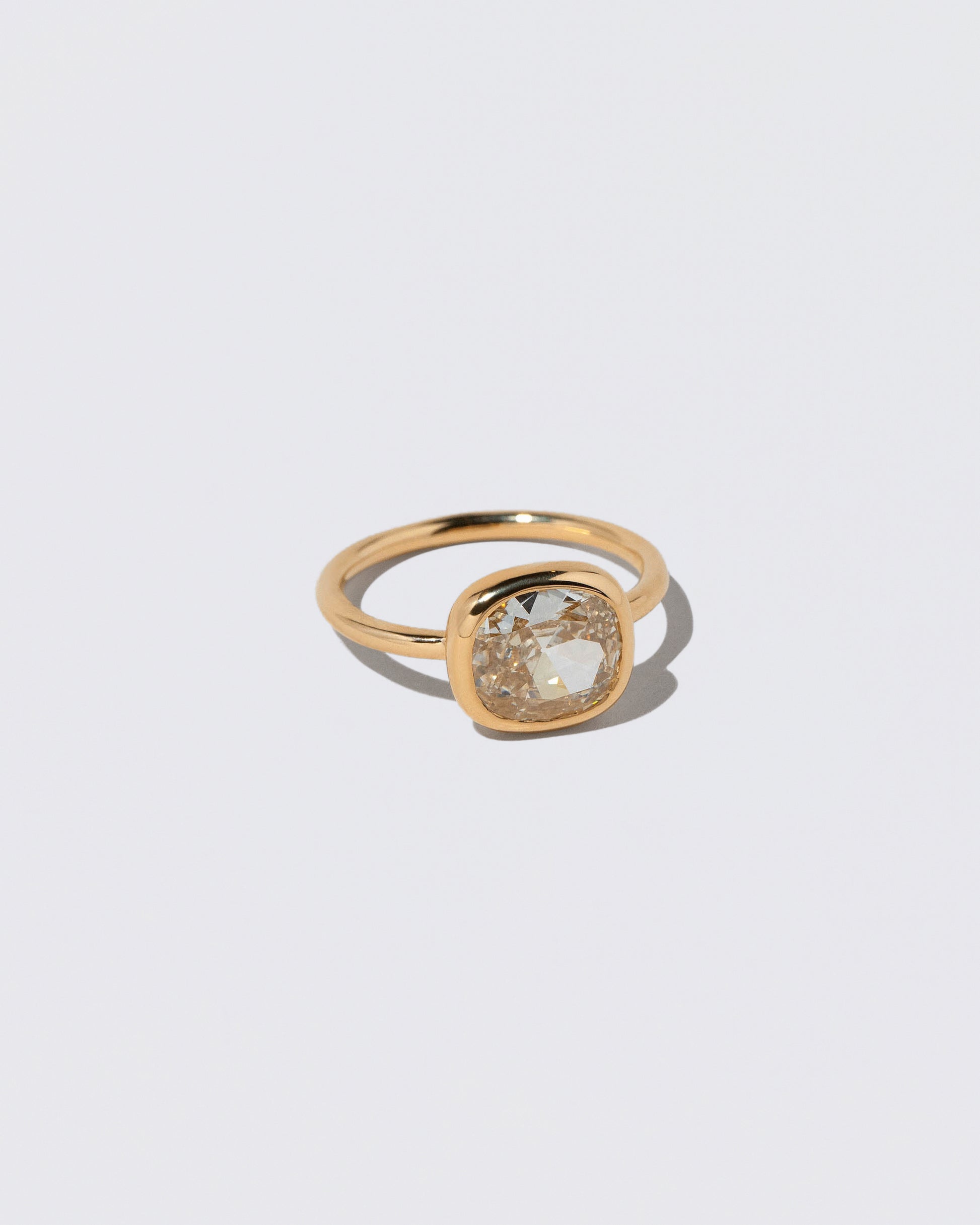 View from the side of the Gusher Diamond Ring 044 on light color background.