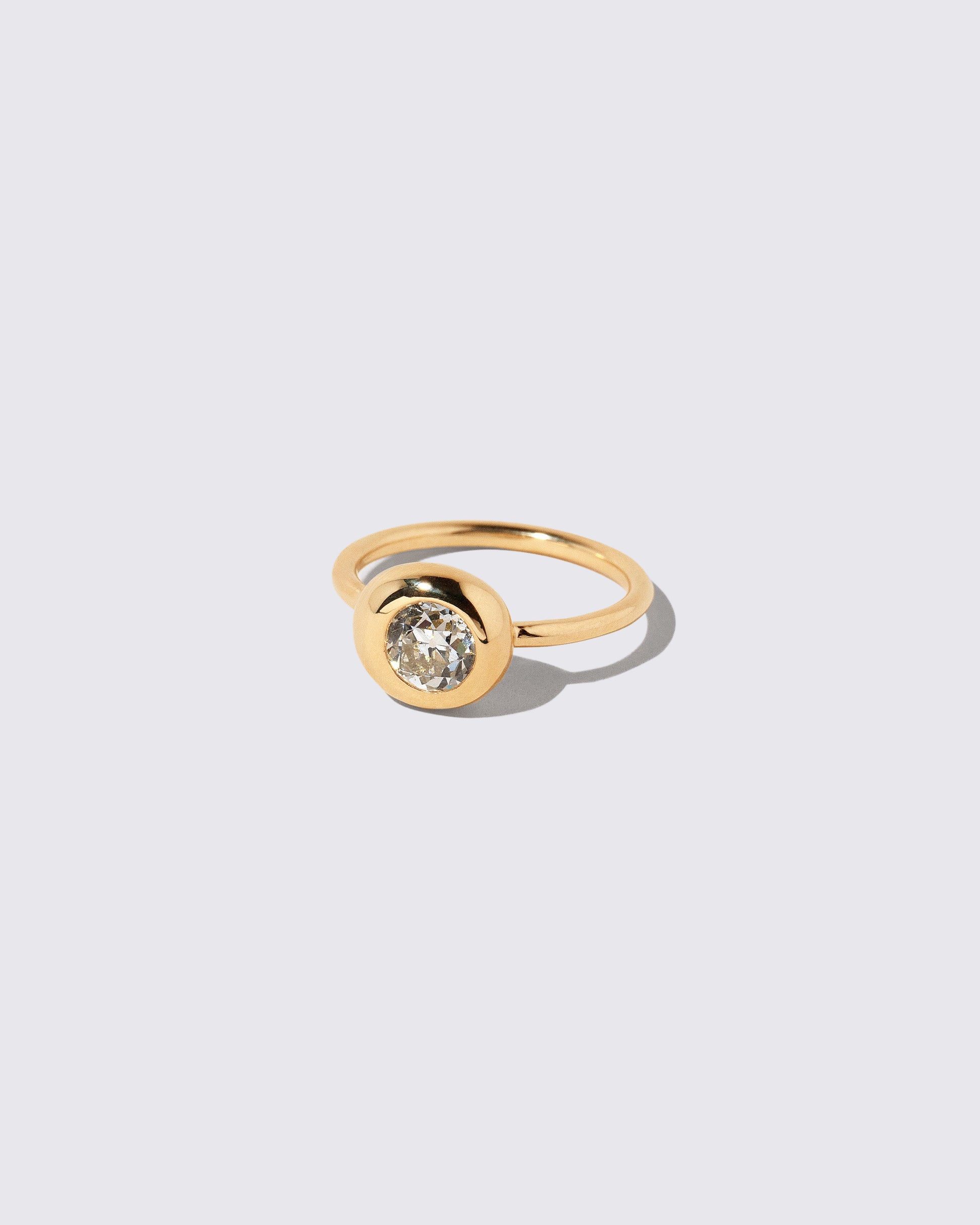 View from the side of the Diamond Level Ring on light color background.