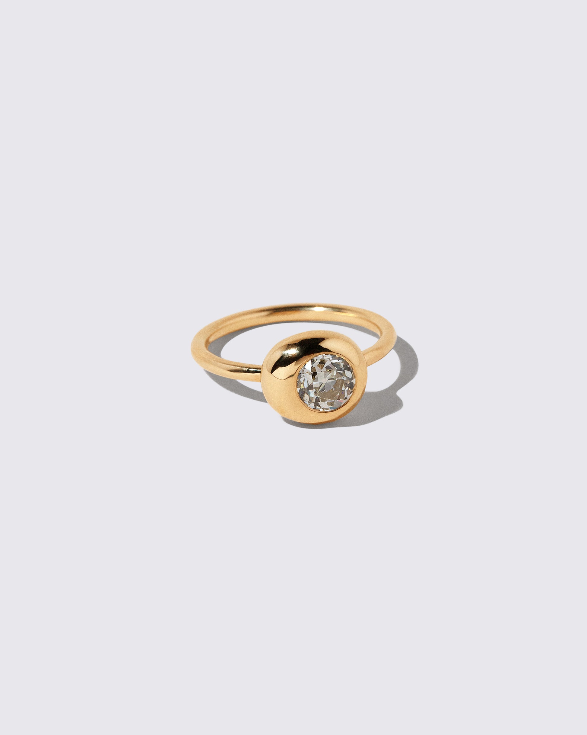 View from the side of the Diamond Level Ring on light color background.