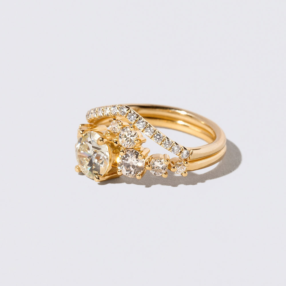 product_details::Closeup details of the White Diamond Luna Ring and Gold White Diamond Pavé Luna Peak Band on light color background.