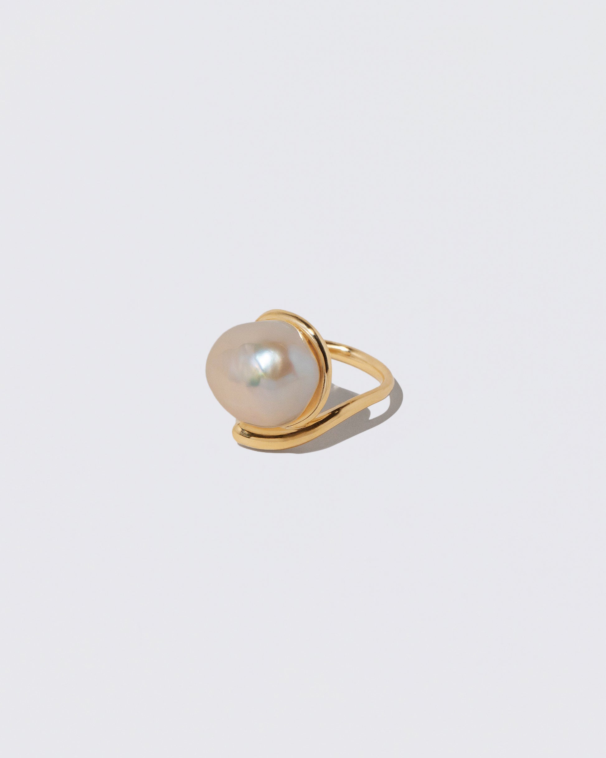View from the side of the Nereus Ring on light color background.