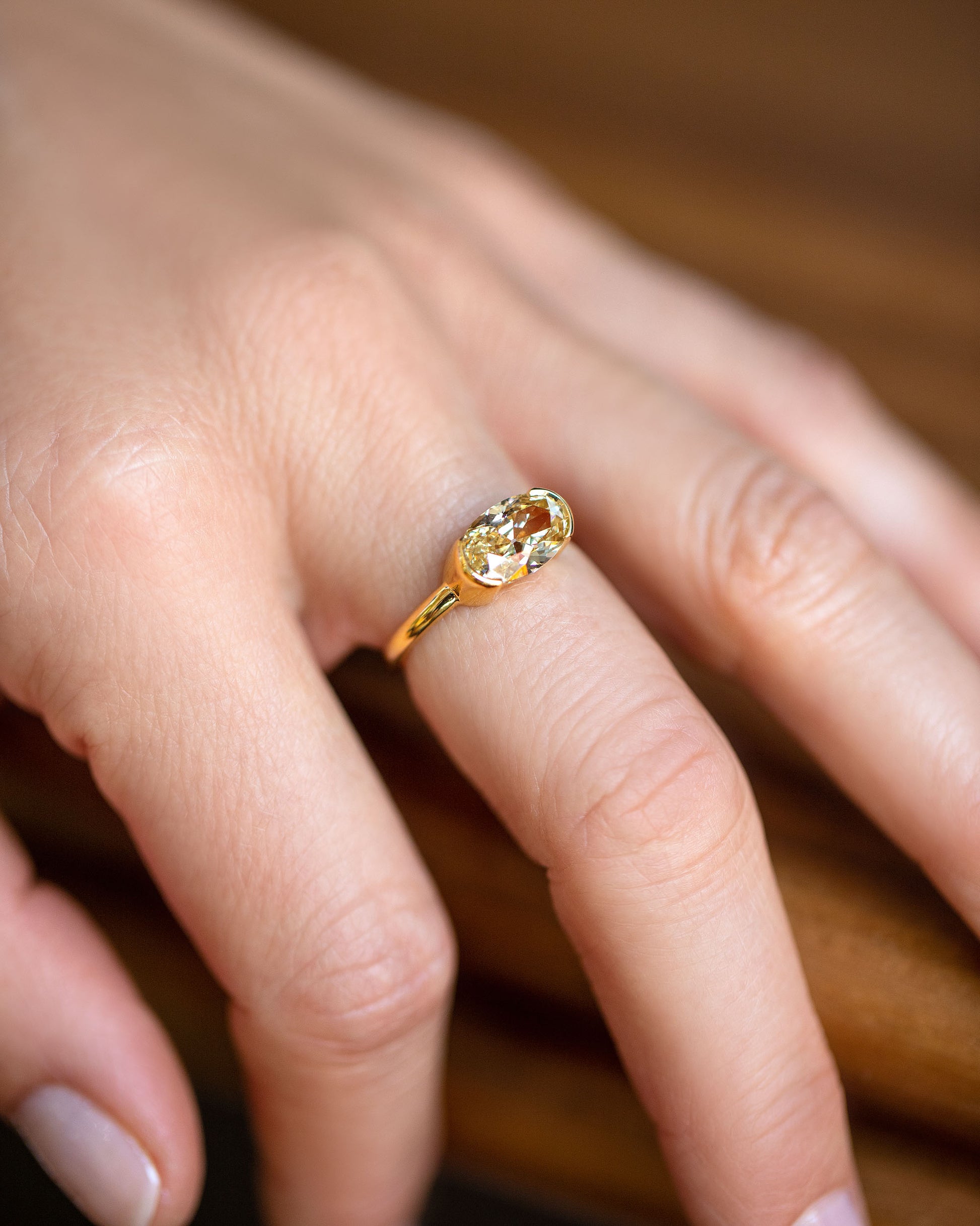 Oval Brown Diamond Transformation Ring on model.