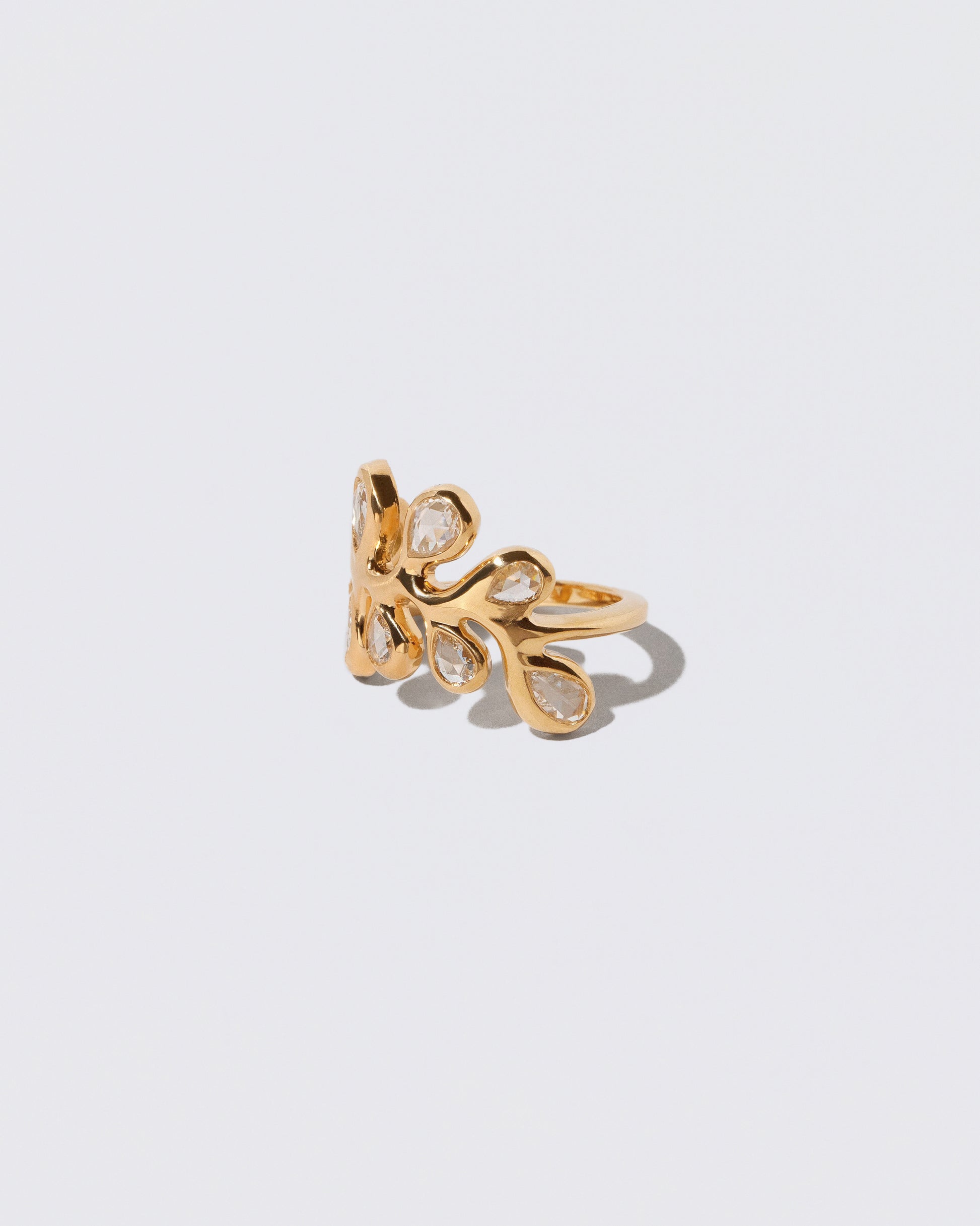 View from the side of the Diamond Palm Ring on light color background.