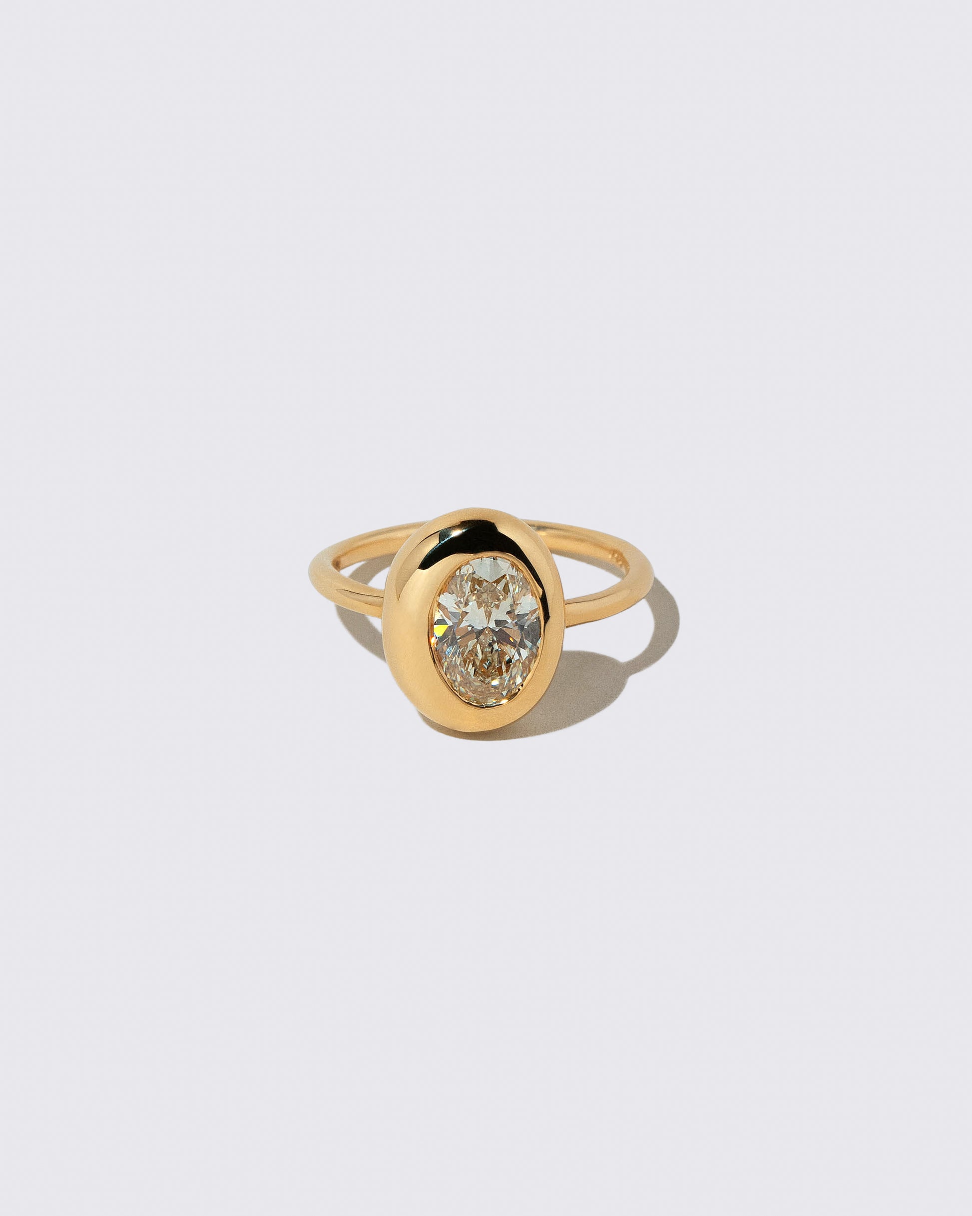 Oval Diamond Precise Ring on light color background.