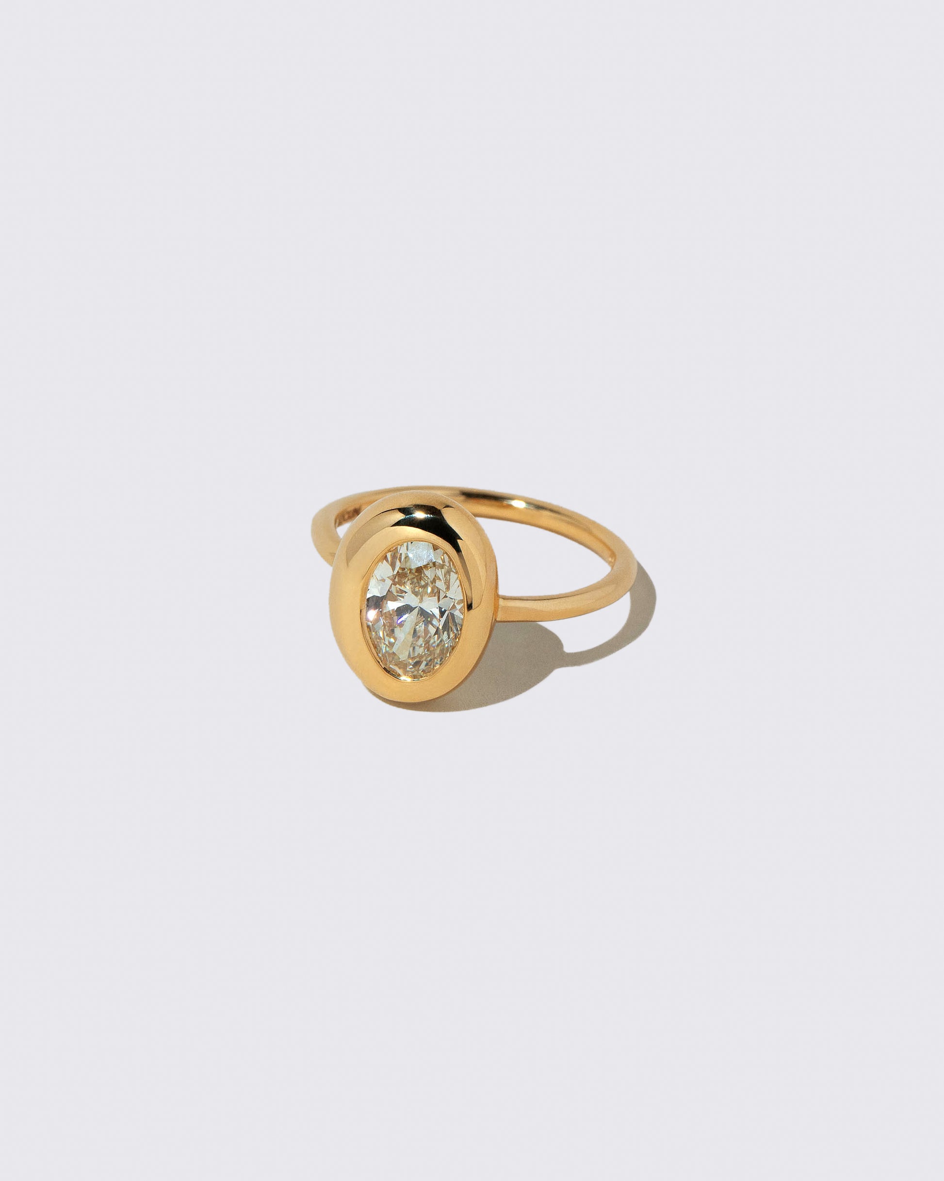 View from the side of the Oval Diamond Precise Ring on light color background.