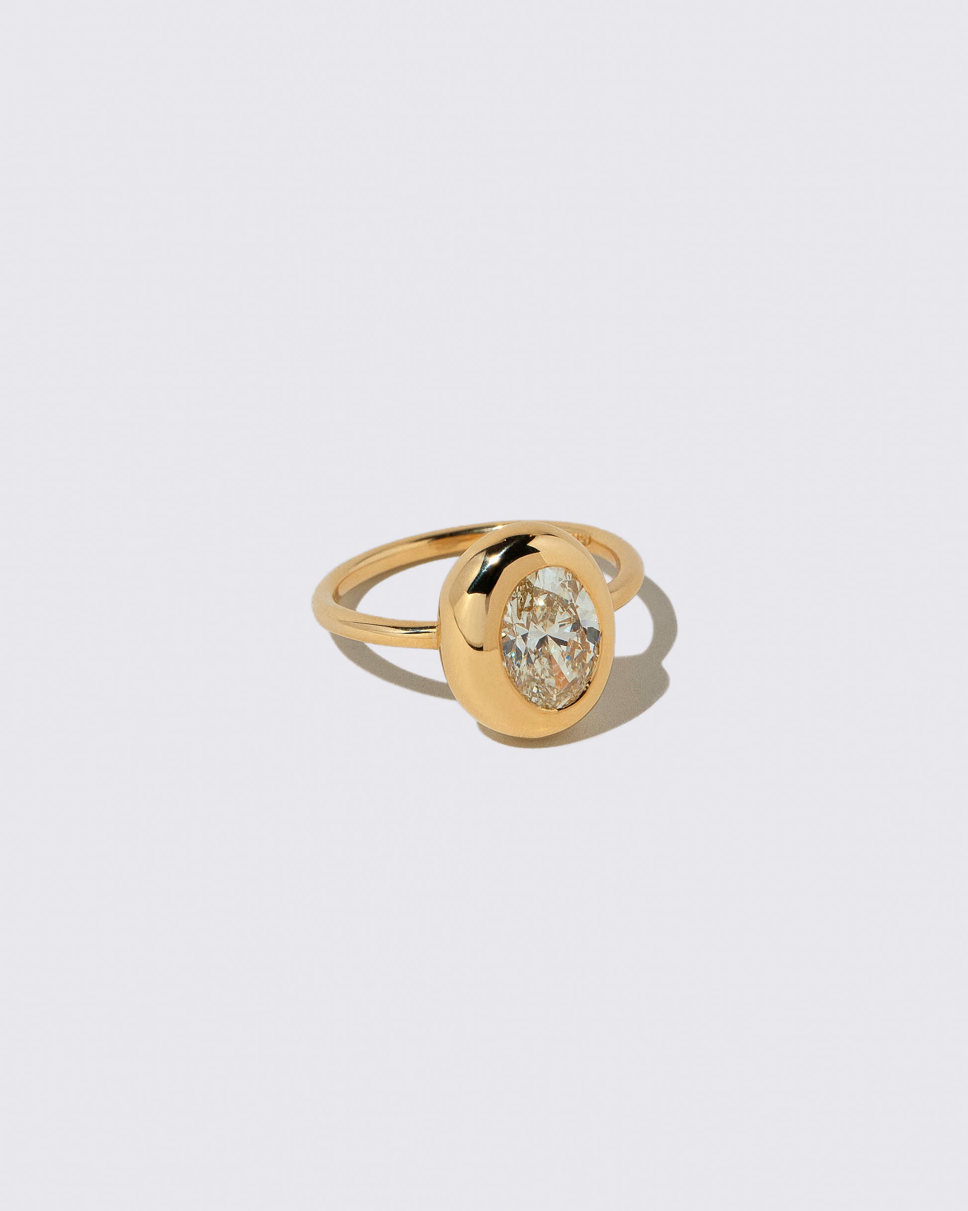 View from the side of the Oval Diamond Precise Ring on light color background.