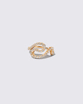 Gold White Diamond Tsunami Ring on light color background.