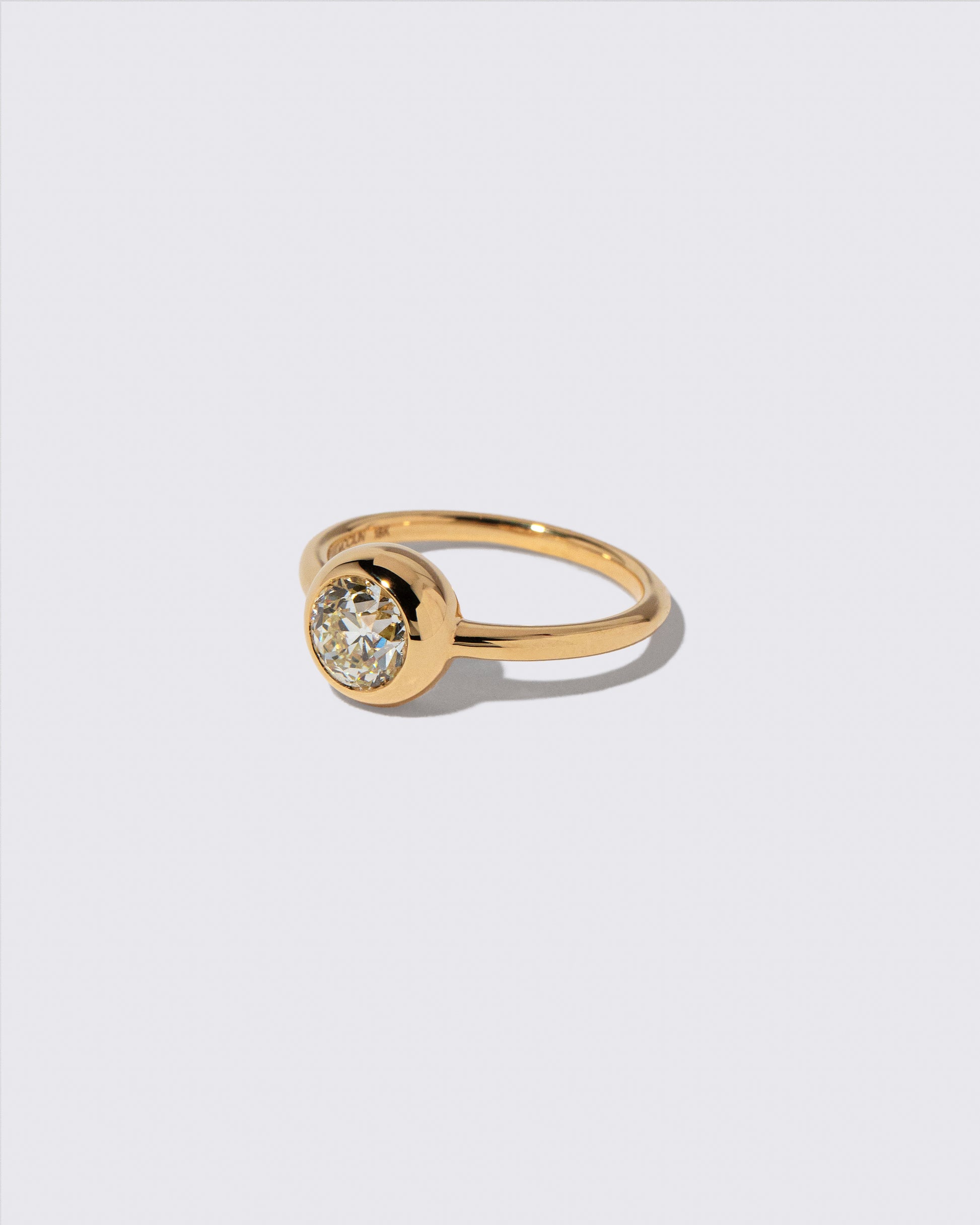 View from the side of the Diamond Wellspring Ring on light color background.