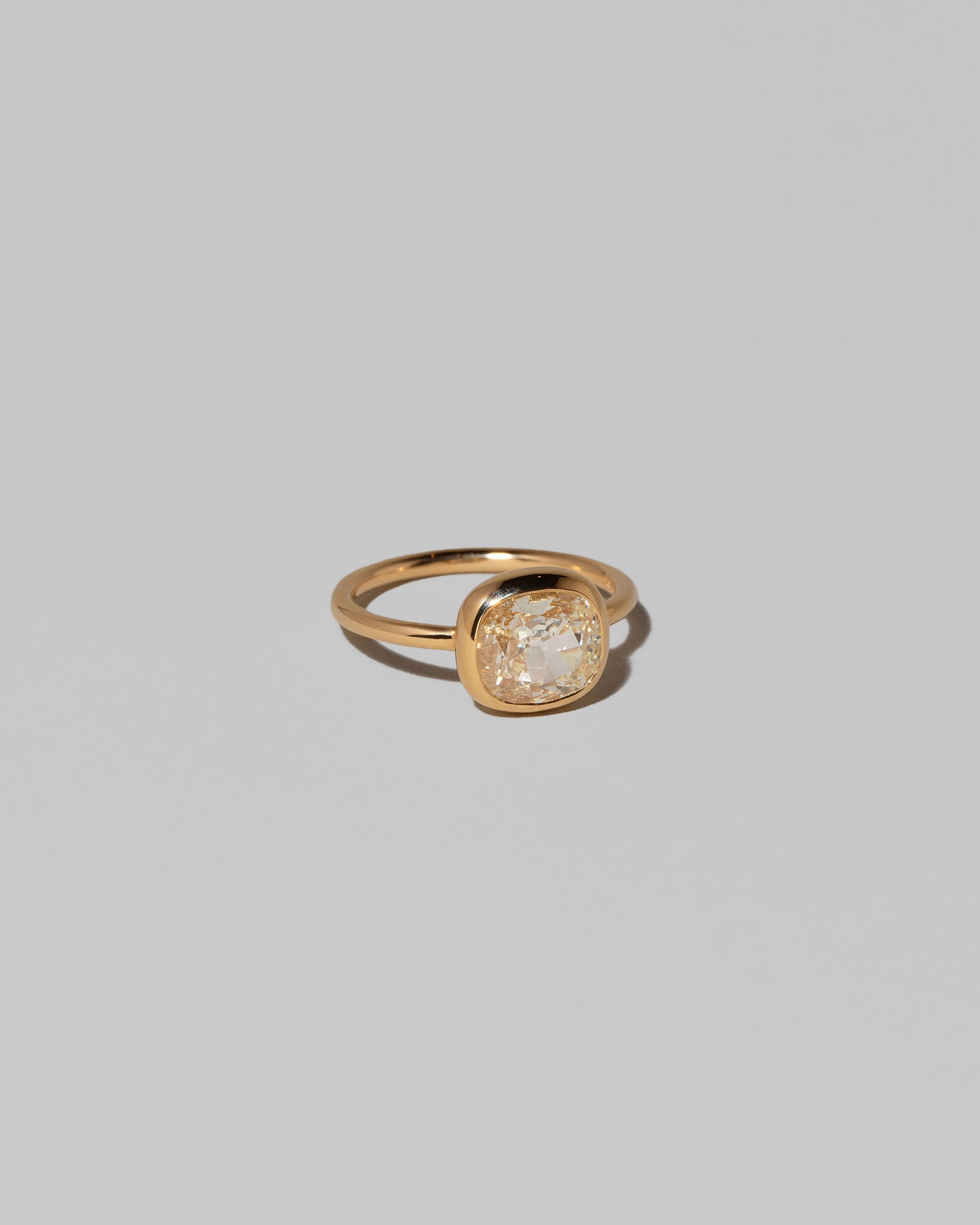 View from the side of the Gusher Diamond Ring 015 on light color background.