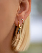 Sardine Charm and Saltine Cracker Charm paired with Link Huggie Hoop Earrings and styled with the Huggie Gold Pavé Snack Hoop Earrings on model.
