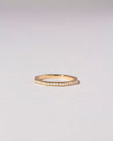 Gold Pavé 2mm Segmented Half Hoop Band on light color background.